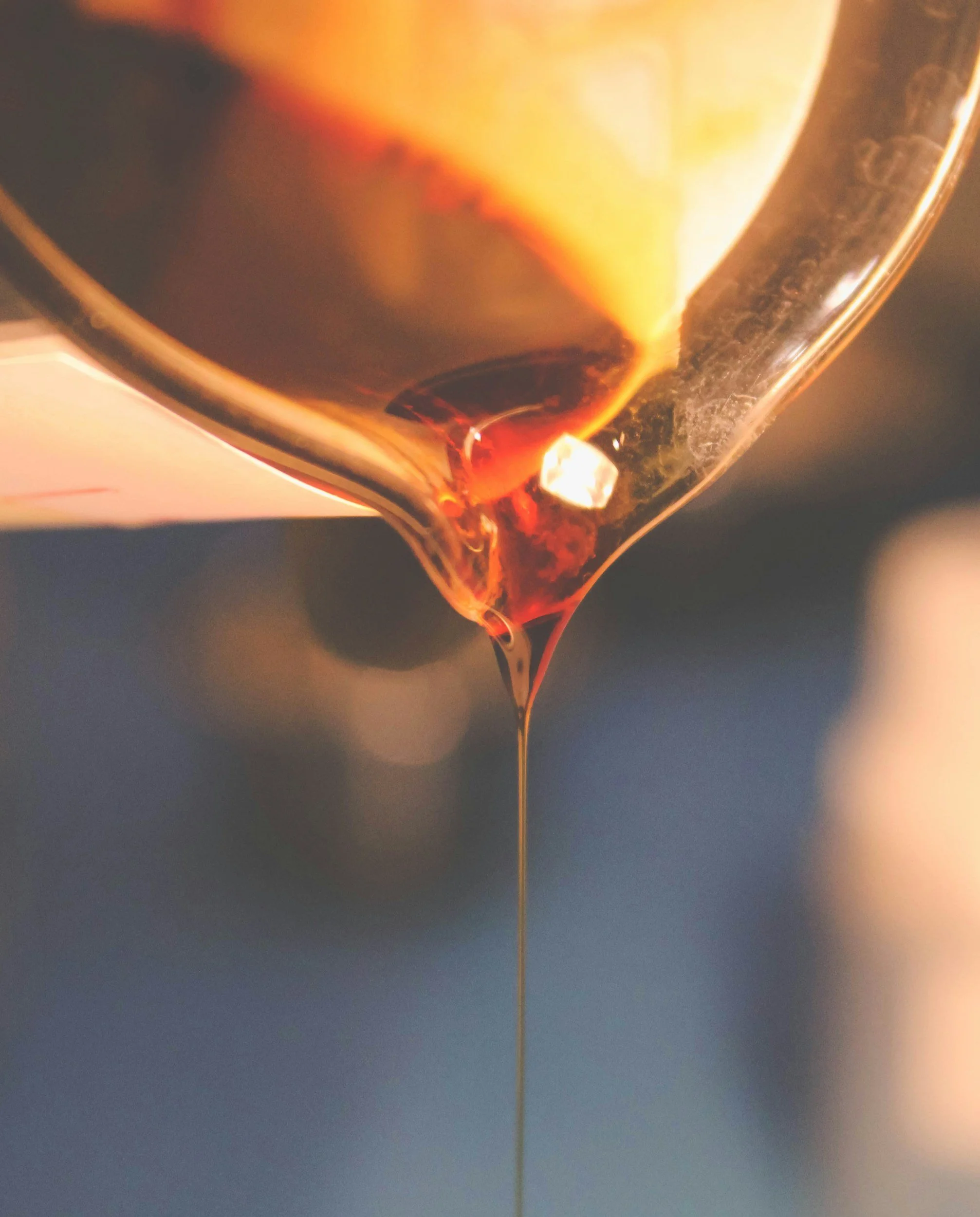The process of making the sugaring paste for sugaring and waxing hair removal. The image displays the warm sugaring paste being poured into a container to cool before being used to make the skin clean and smooth.