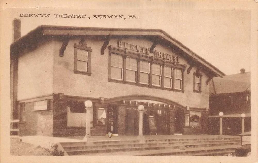 An old sepia-toned photograph of the Berwyn Theatre in Berwyn, Pennsylvania, showing a two-story building with a marked entrance, glass doors, multiple windows, and a sign that reads 'Berwyn Theatre' above the entrance, with steps leading up to the building.