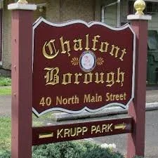 A street sign for Chalfont Borough at 40 North Main Street, with an additional directional sign pointing to Krupp Park.