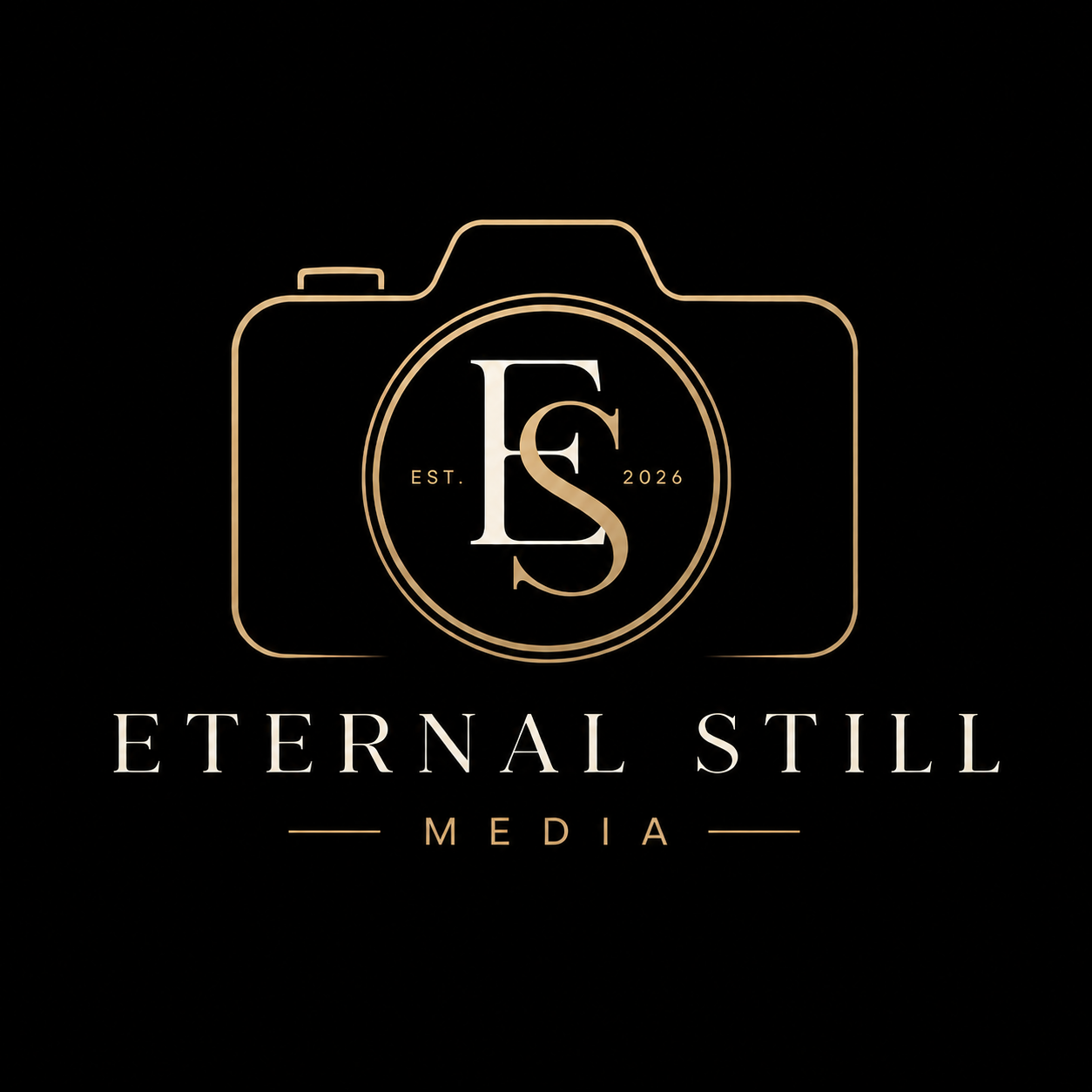 A black background with a gold outline of a camera. Inside the camera outline, there is a circular logo with the letters 'E' and 'S' intertwined, and the text 'EST. 2026' on either side. Below, the words 'ETERNAL STILL' are written in large white font, with 'MEDIA' underneath in smaller gold font.