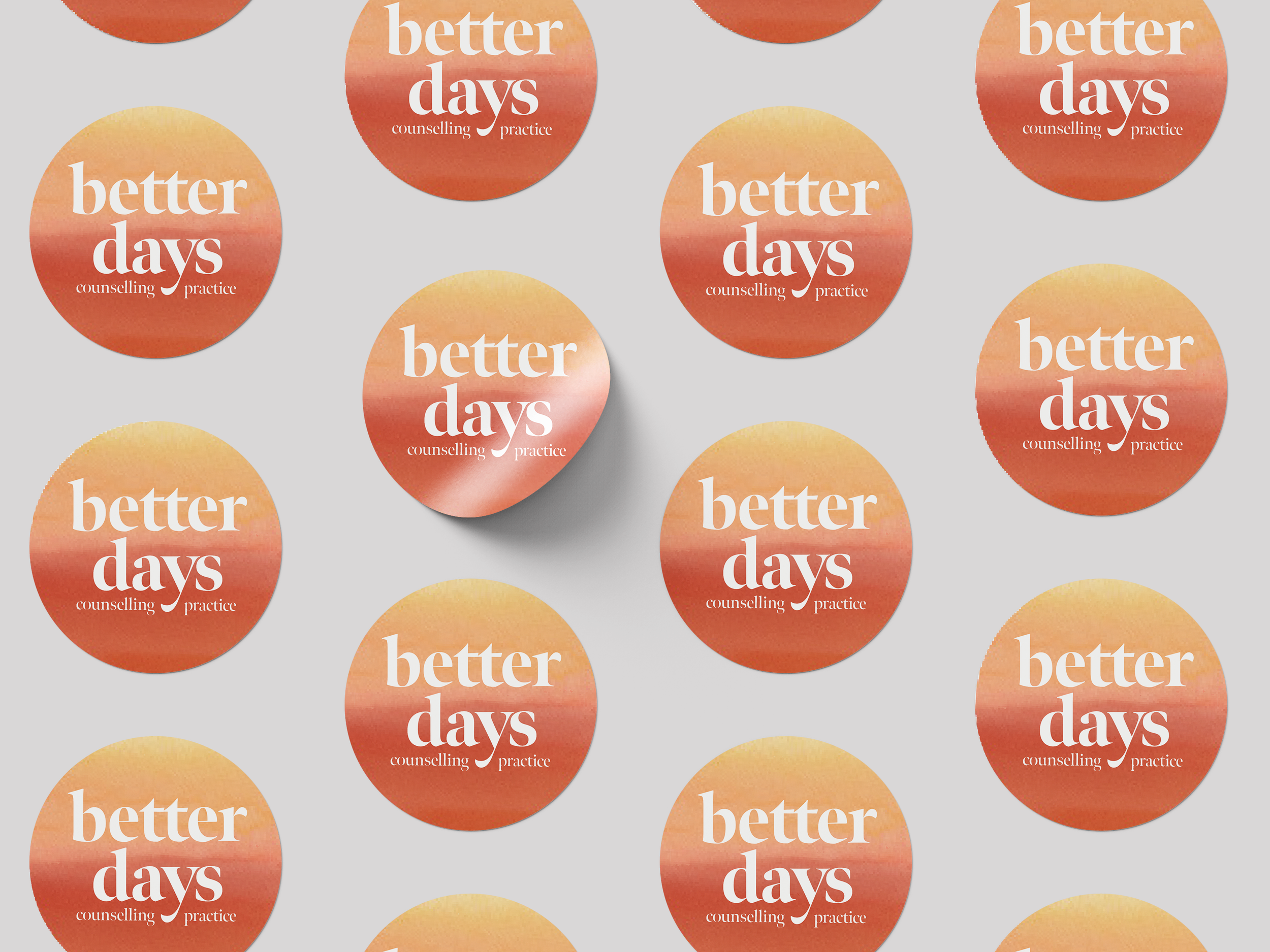 Multiple round stickers with a sunset gradient background, each displaying the text 'better days' in large white font, and 'counselling practice' in smaller white font underneath.