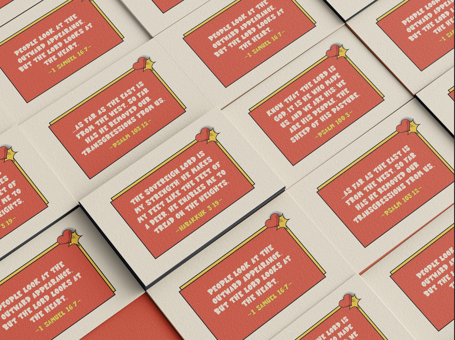 Multiple prayer cards with Bible verses in red and yellow, decorated with a heart and star graphic on a beige surface.