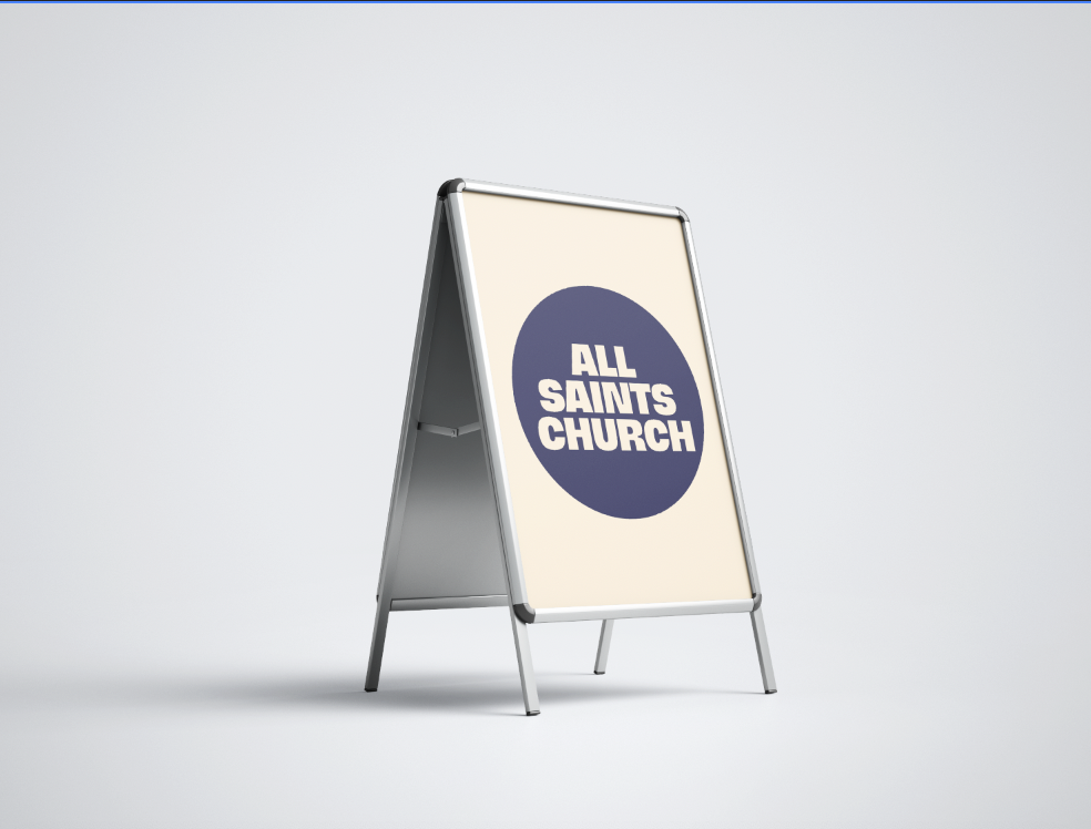 A sandwich board sign with a beige background and a dark blue circle in the middle that says "ALL SAINTS CHURCH" in white text.