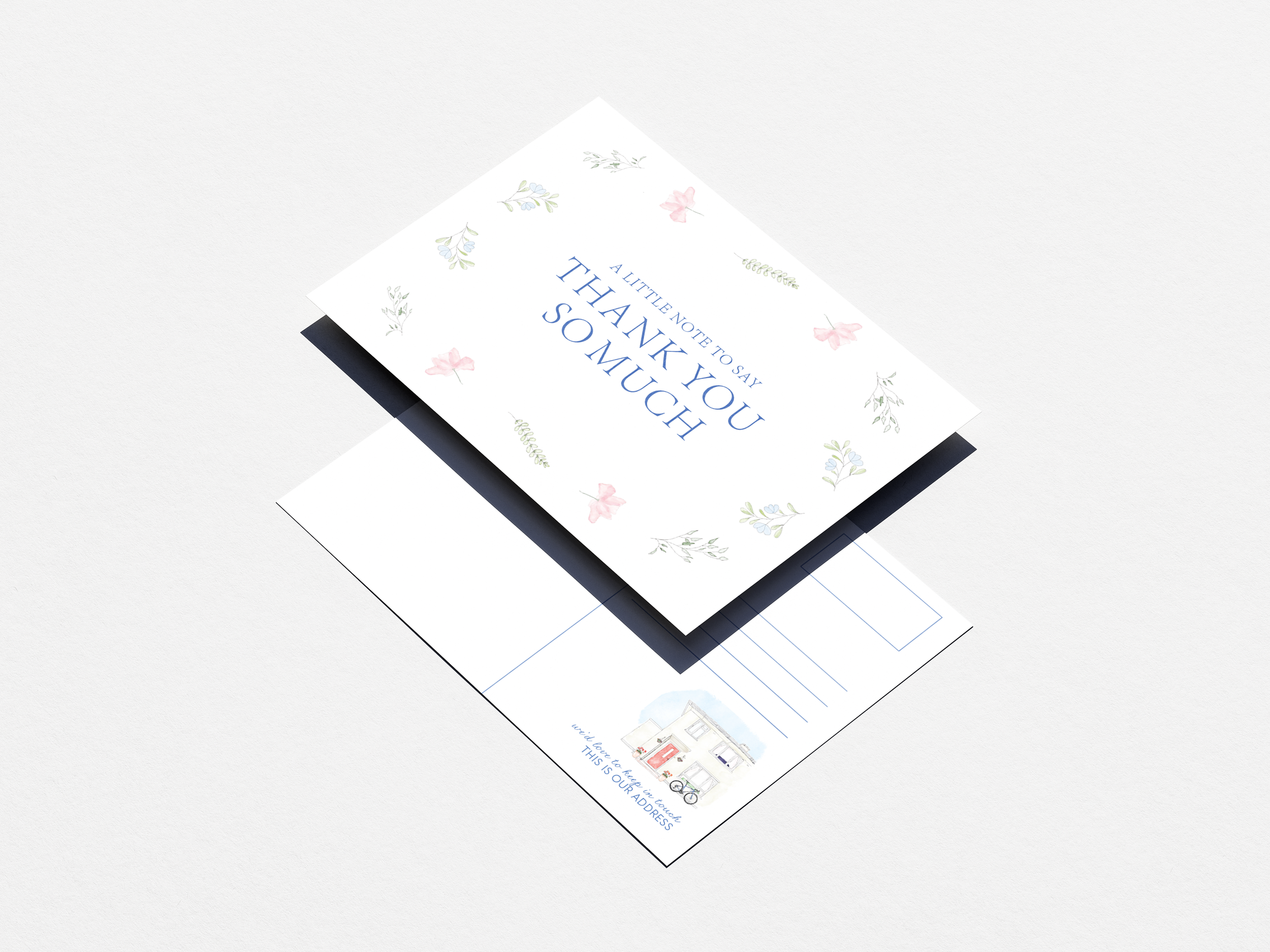 A note card with a floral design on the cover and a message inside, and a detailed illustration of a house with a bicycle outside.