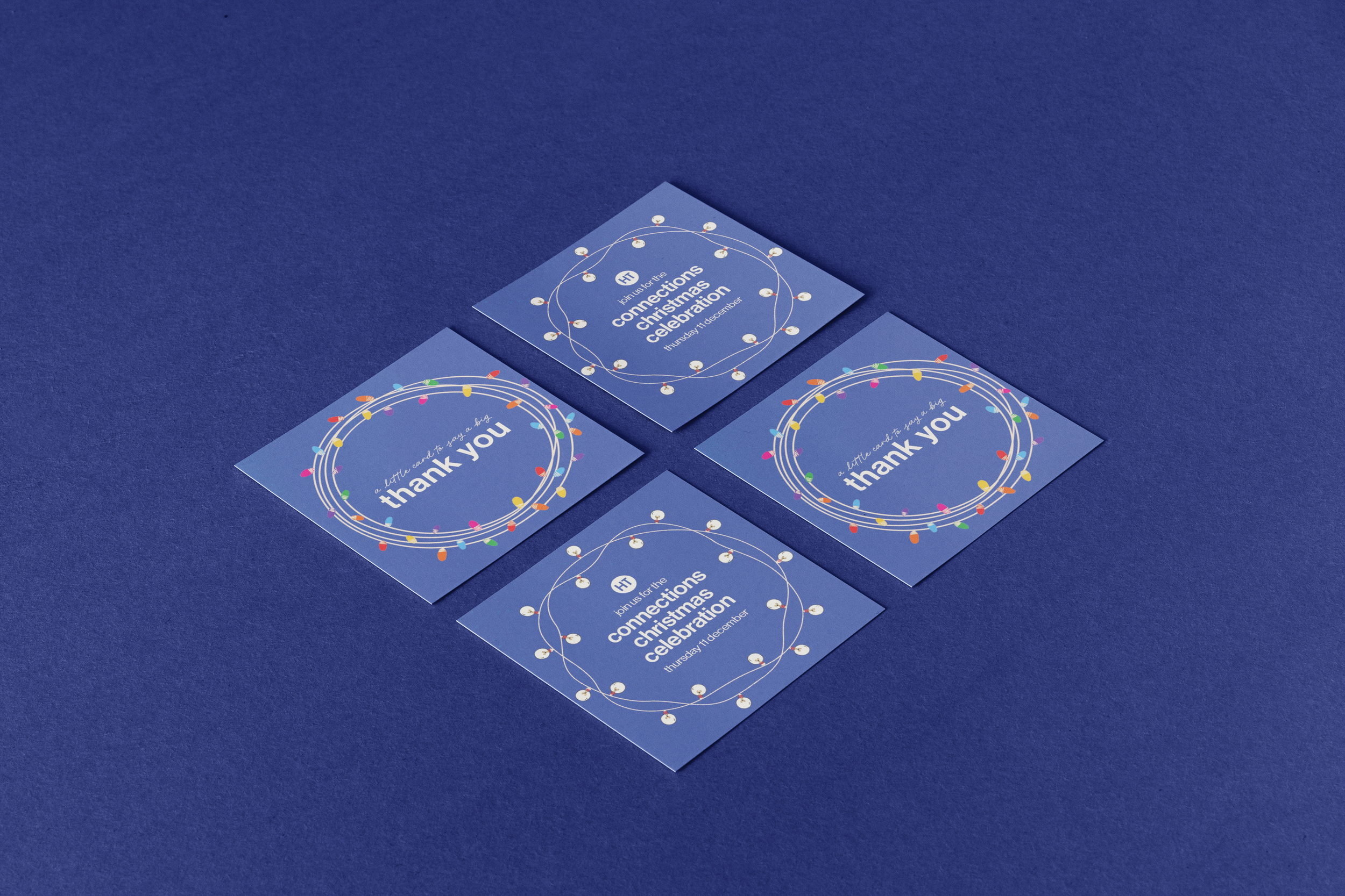 Four blue Christmas celebration cards with colourful light bulb borders and white text, placed on a dark blue surface. One card invites joining the 'Connections Christmas Celebration' with the others saying 'a little card to say a big thank you'.
