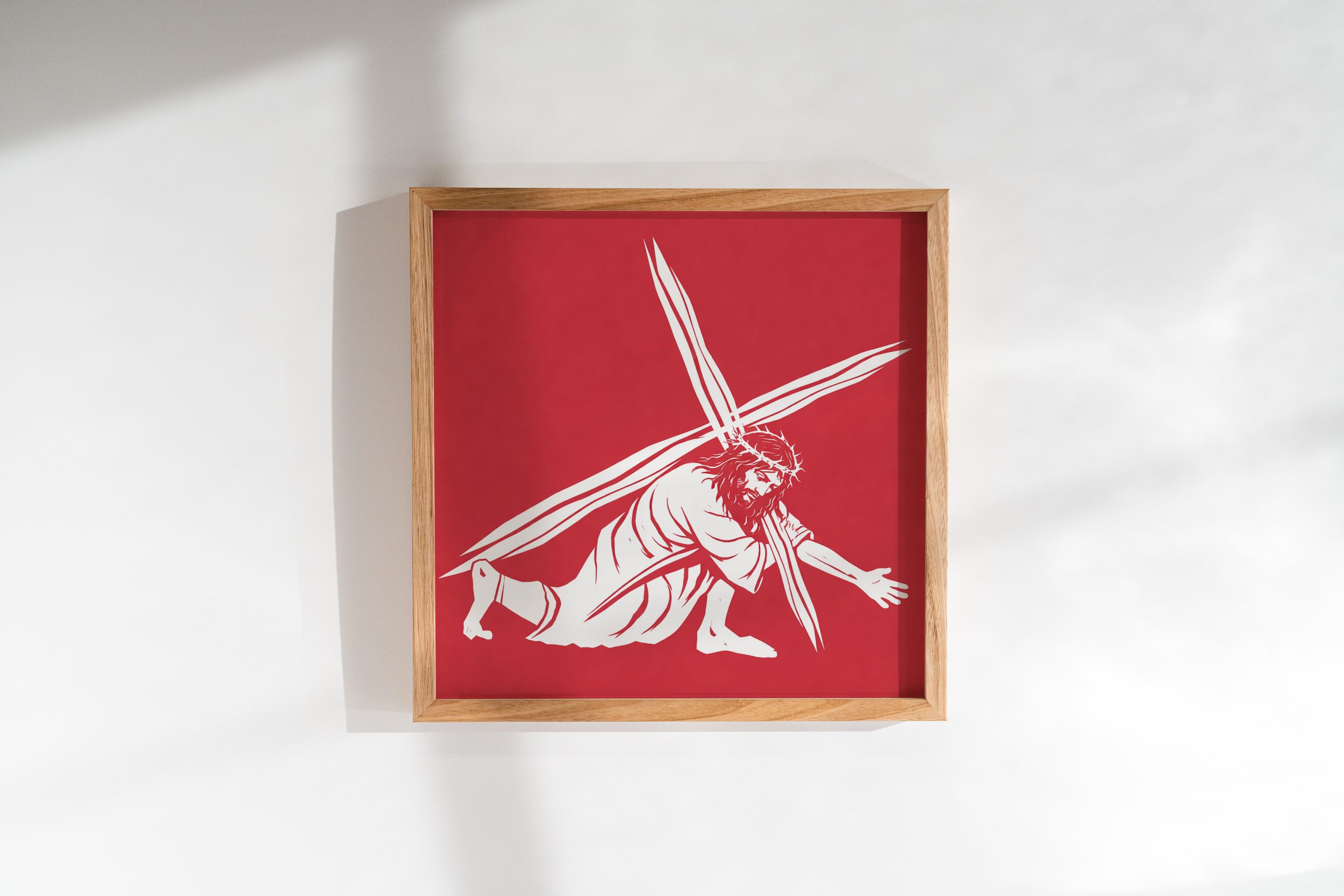 Framed artwork with a white outline drawing of Jesus Christ on a red background.