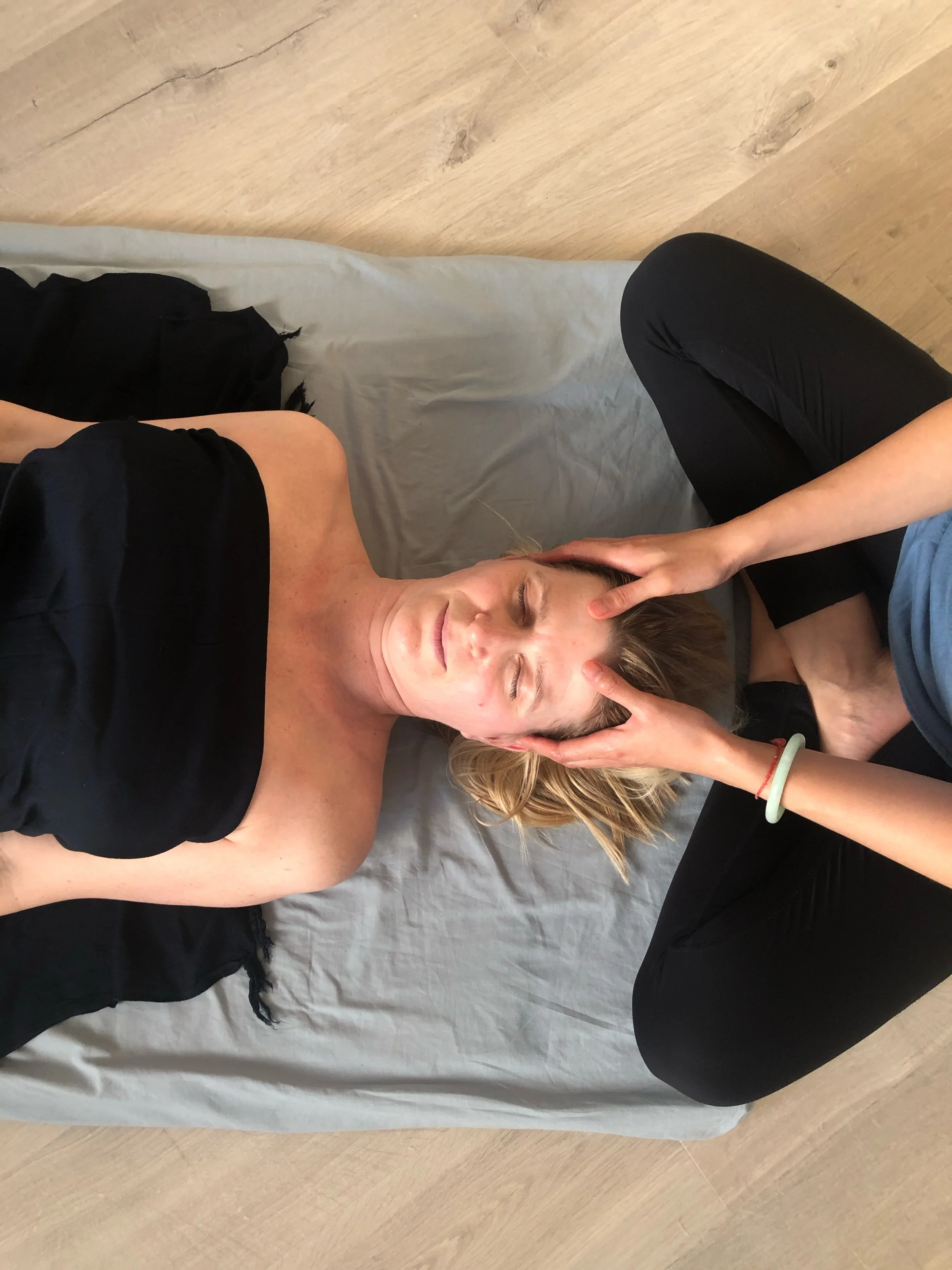 A soothing face and head massage during an Ayurvedic Yoga Massage treatment.