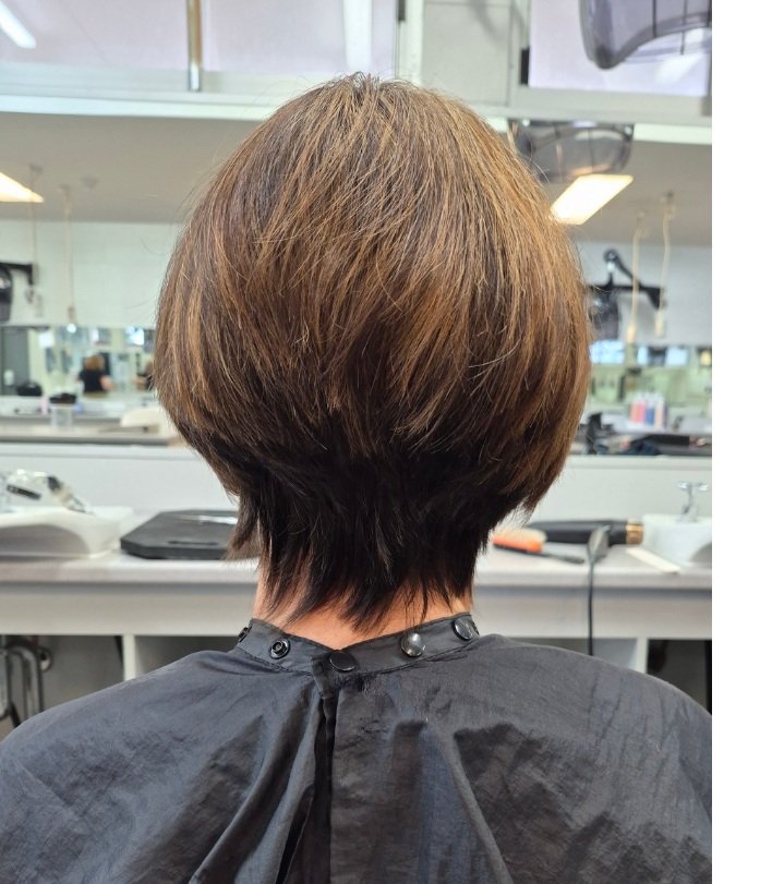 uniform layer hair cut woman sitting in hairdresser chair 