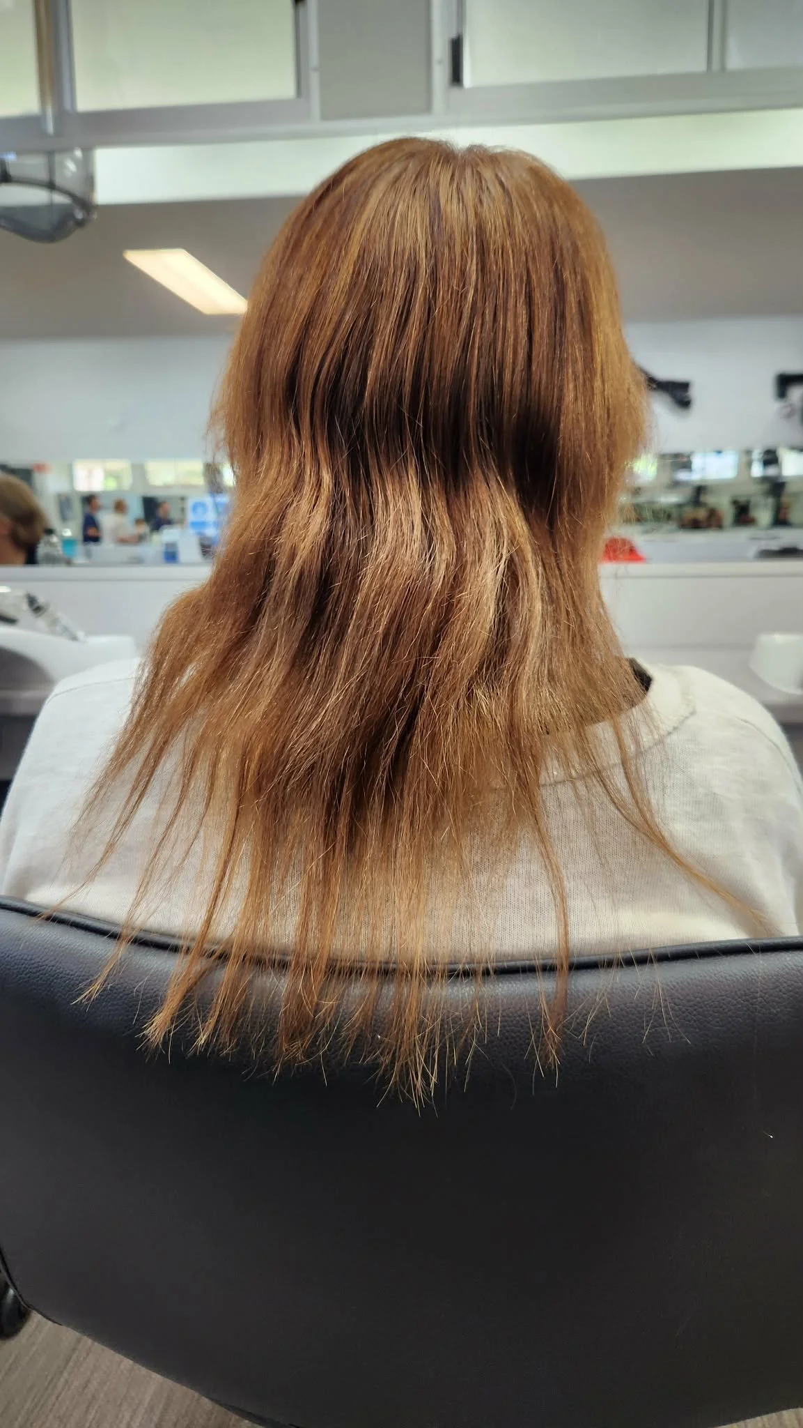 uniform layer hair cut woman sitting in hairdresser chair