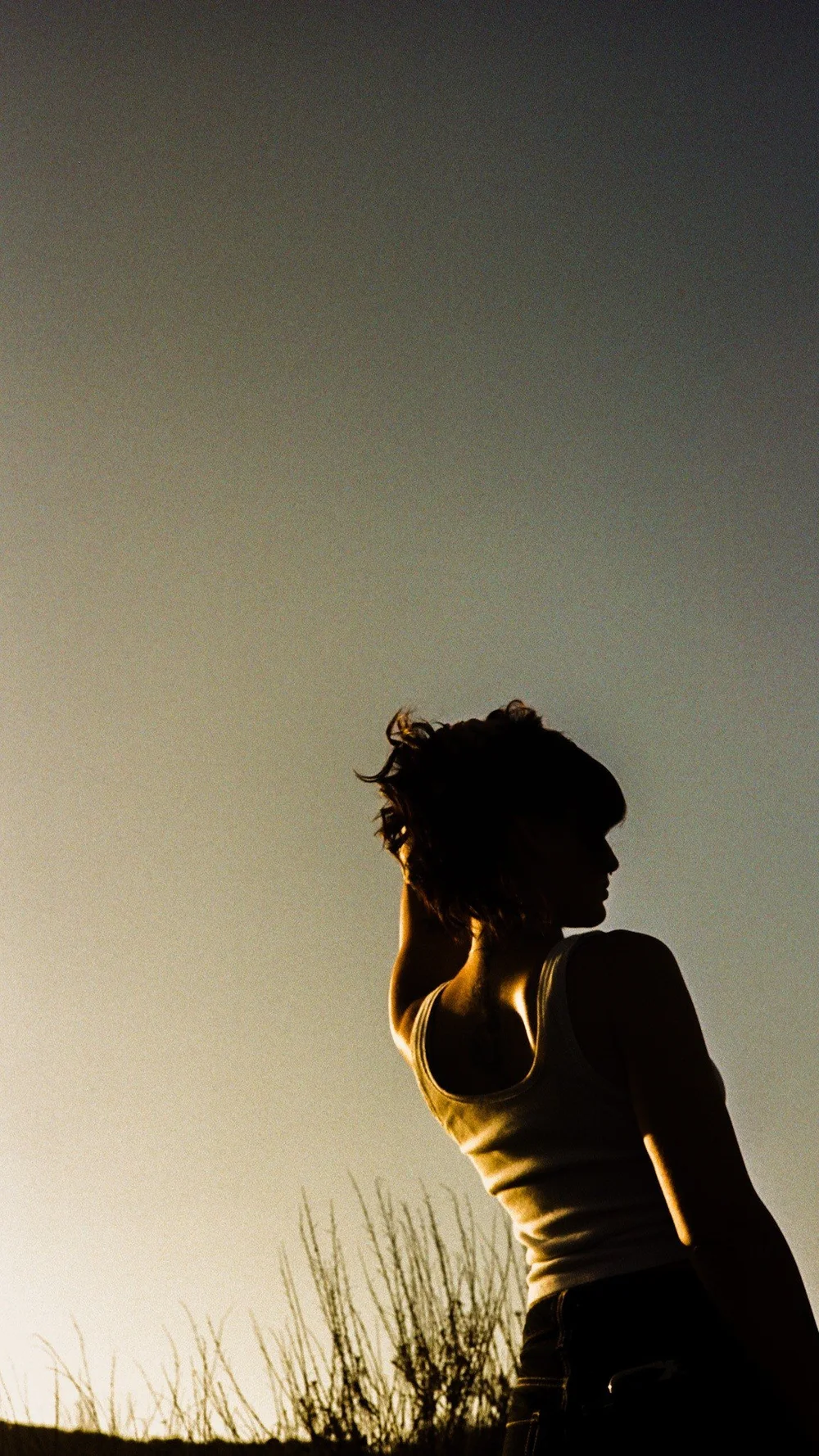 Laurel in silhouette against the evening sky in El Cajon, shot on 35mm film