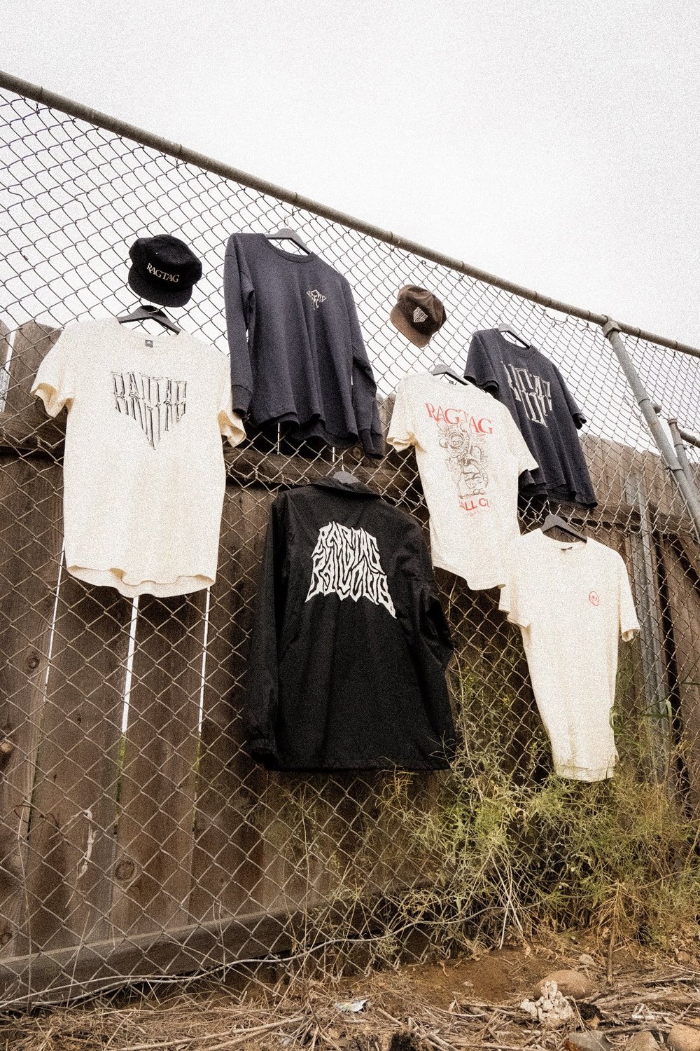 The full Ragtag Ballclub collection hung along a chain-link fence in San Diego