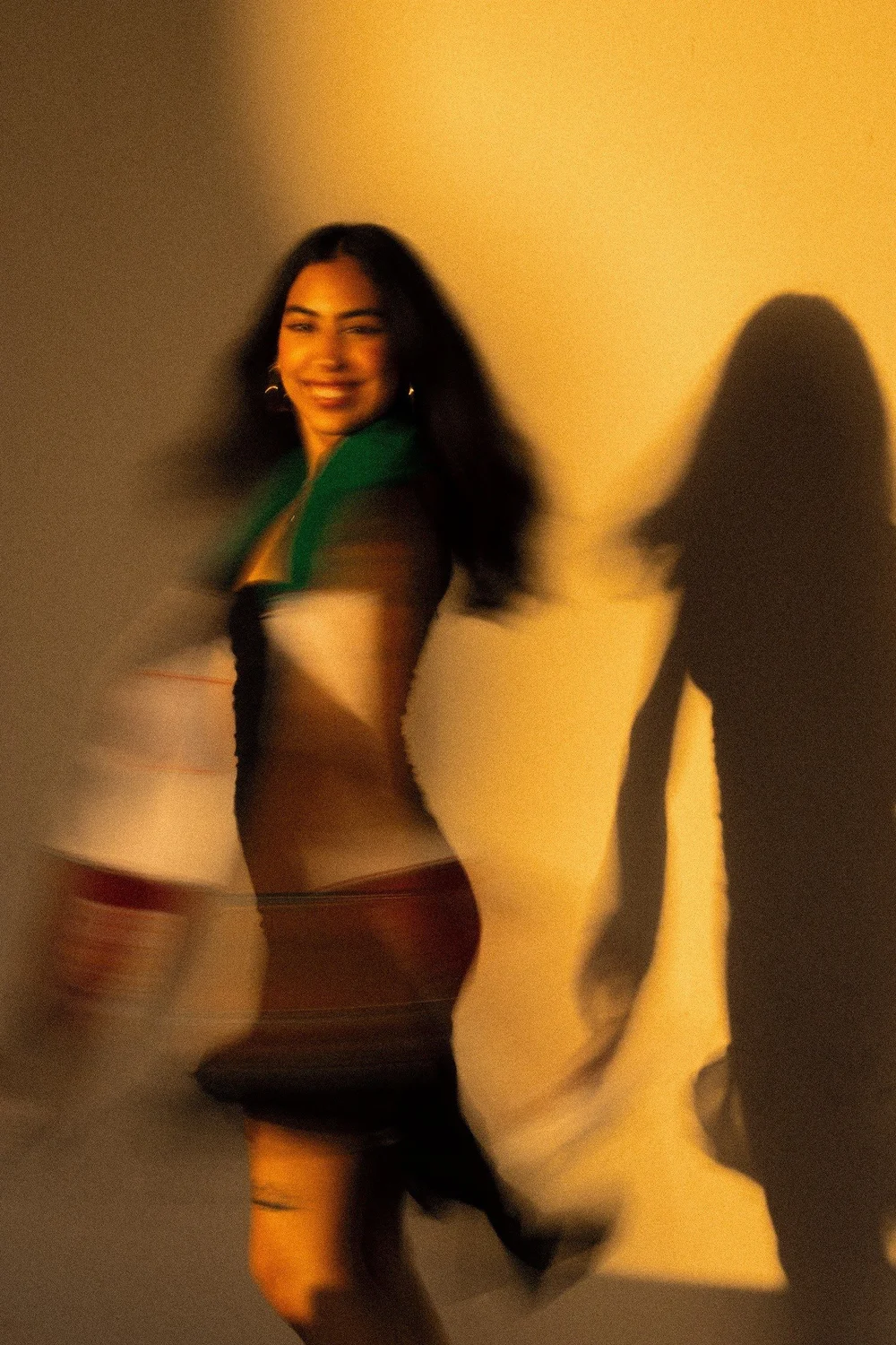 Magaly turning in motion blur beside her shadow