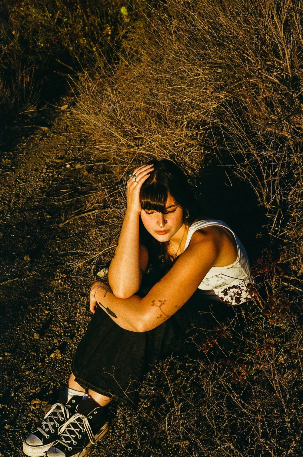 Laurel sitting in dry grass in El Cajon, shot on 35mm film