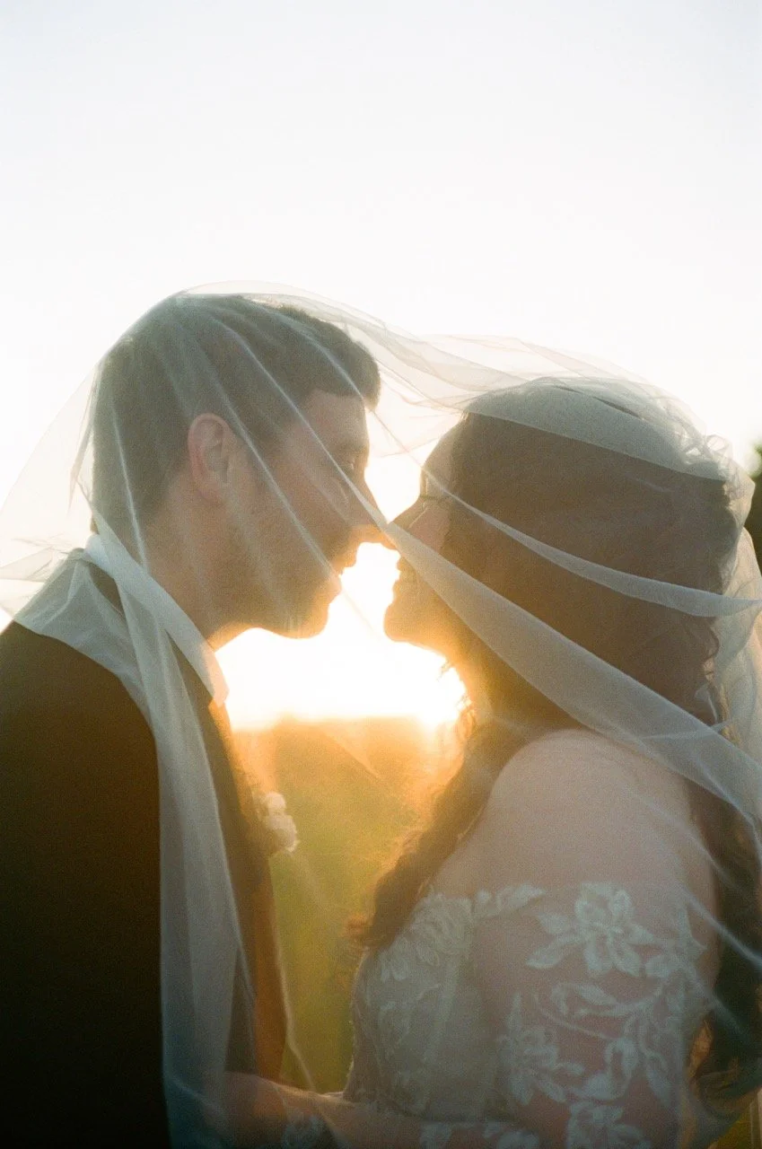 Carley and Preston close under her veil with the sun between them, shot on film