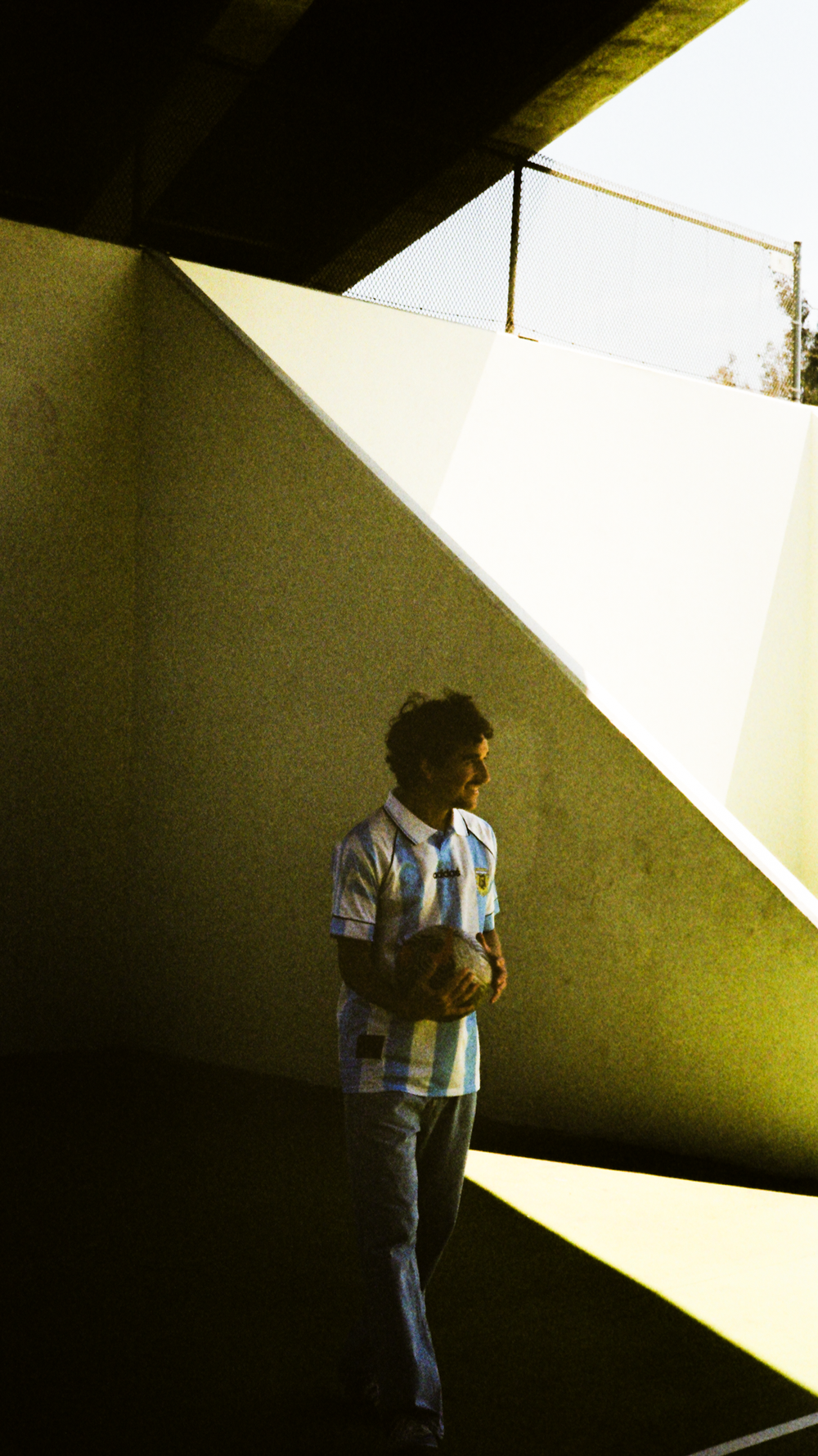 The Argentina kit in a shadowed corner of the court, shot on film
