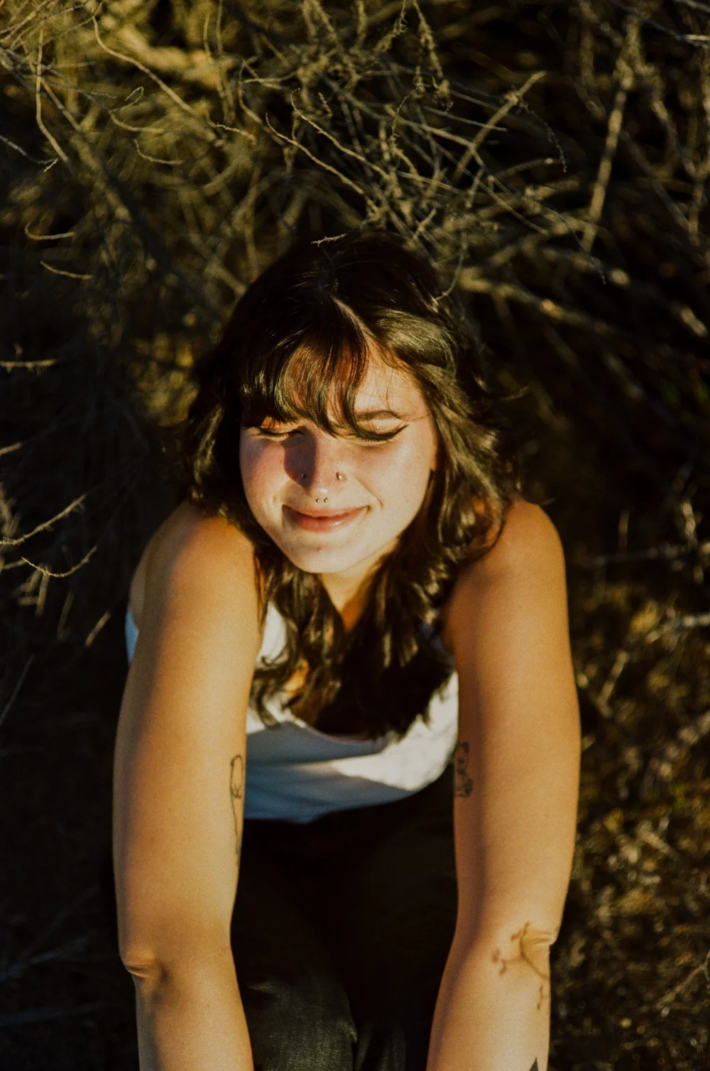 Laurel smiling in the dry grass in El Cajon, shot on 35mm film
