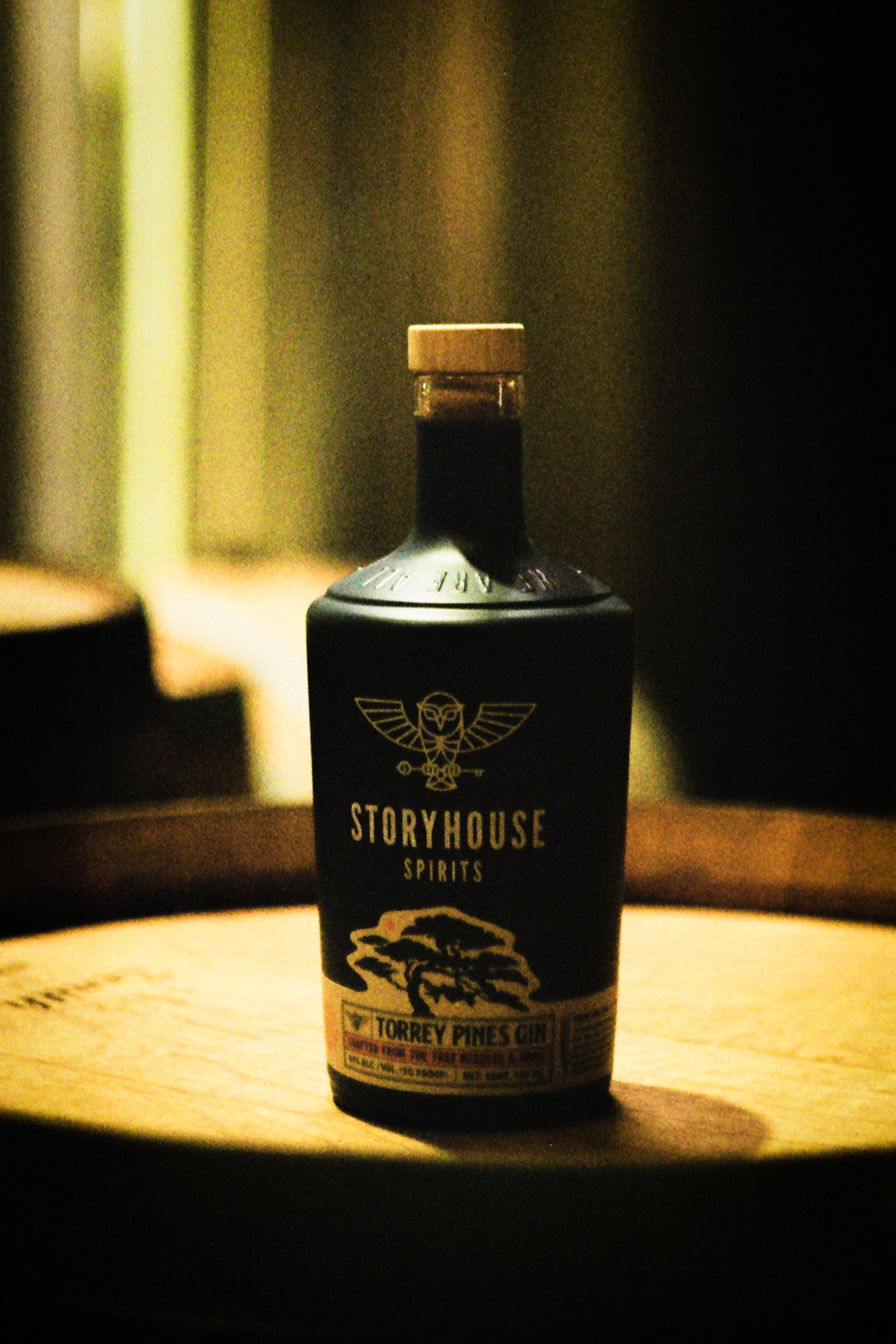 A Storyhouse bottle close up on a barrel head, shot on film