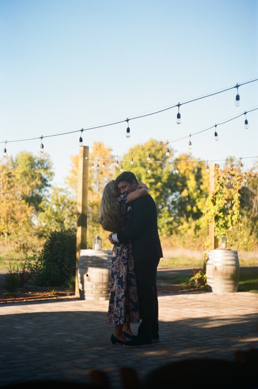 A slow dance on the patio under string lights, shot on film