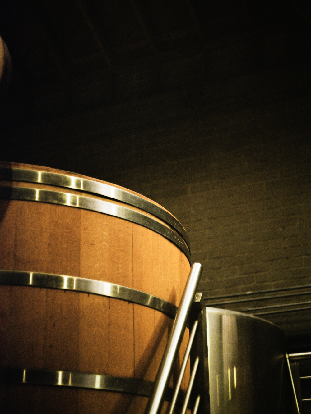 The curve of a barrel beside the steel still, shot on film