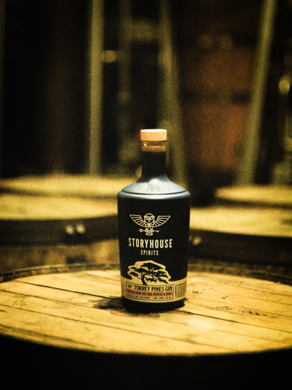 A Storyhouse Spirits bottle on a barrel head in their East Village distillery, shot on 35mm film