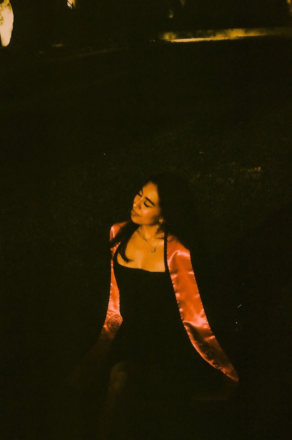 Magaly in her stole in a dark garden at night, shot on film