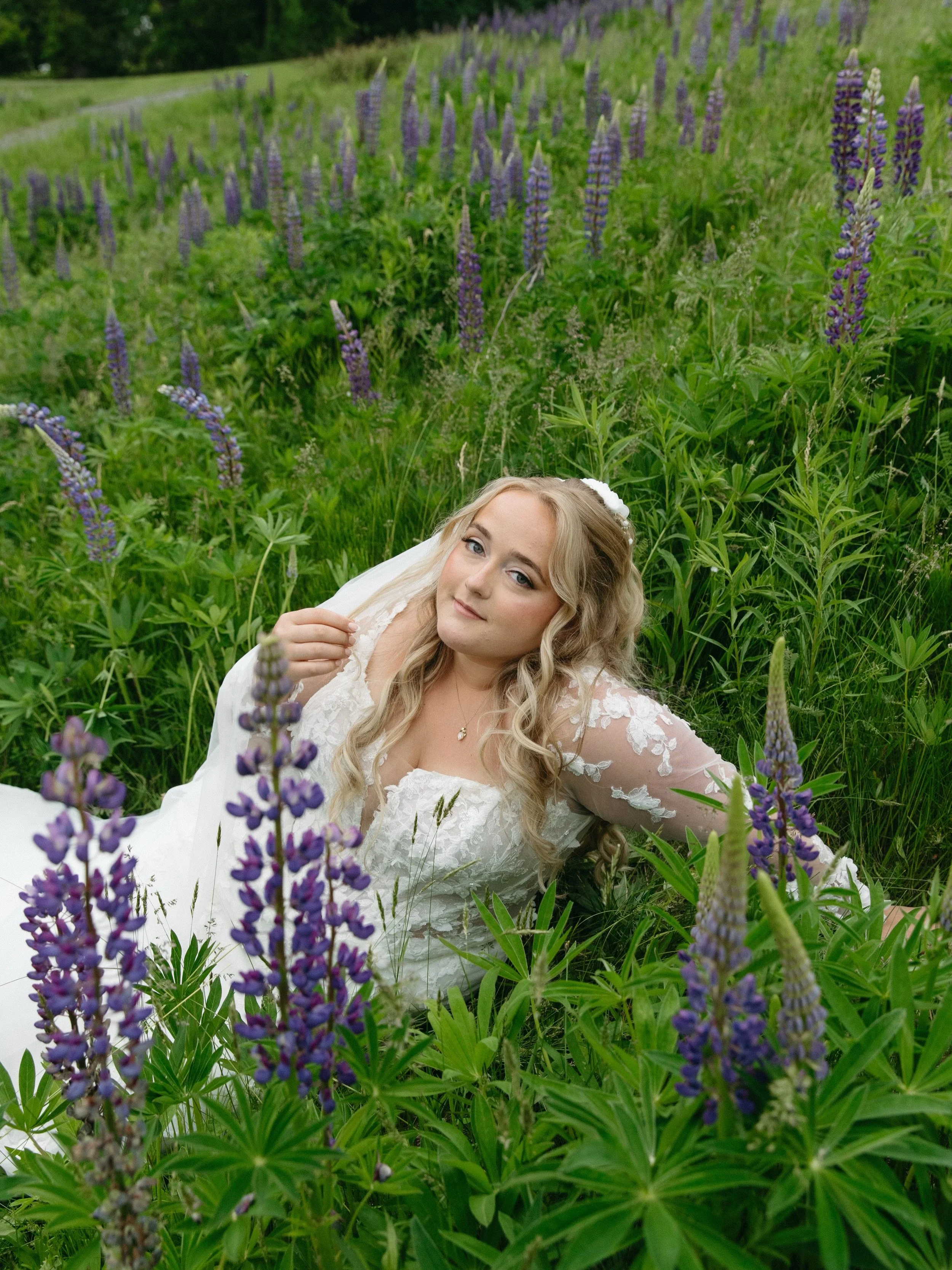 Kaylee &amp; Ethan&rsquo;s wedding day was nothing short of magical 🤍 

Tell me why Kaylee is just casually laying in a field of lupines looking like a literal fairy 🧚🏻&zwj;♀️

Photo by: @loganelizabethphoto.jpg 
Hair by: @hairbyjacke 
Makeup by m