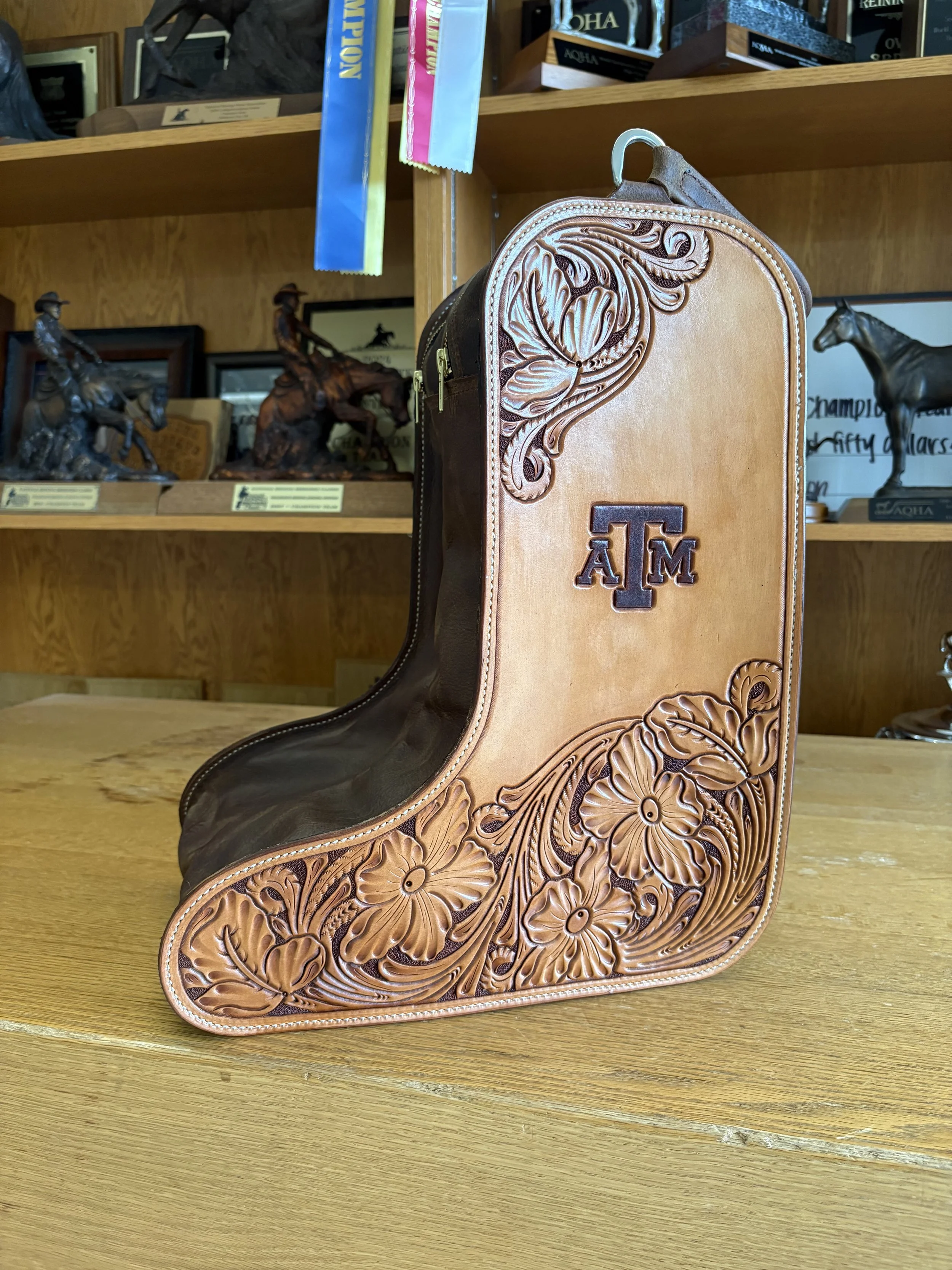 Leather cowboy boot with engraved floral design and the Texas A&M University logo.