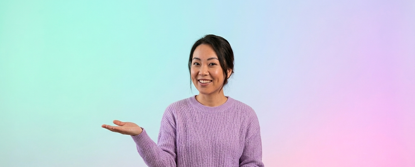 Smiling woman in a lavender sweater holding her left hand out against a pastel gradient background