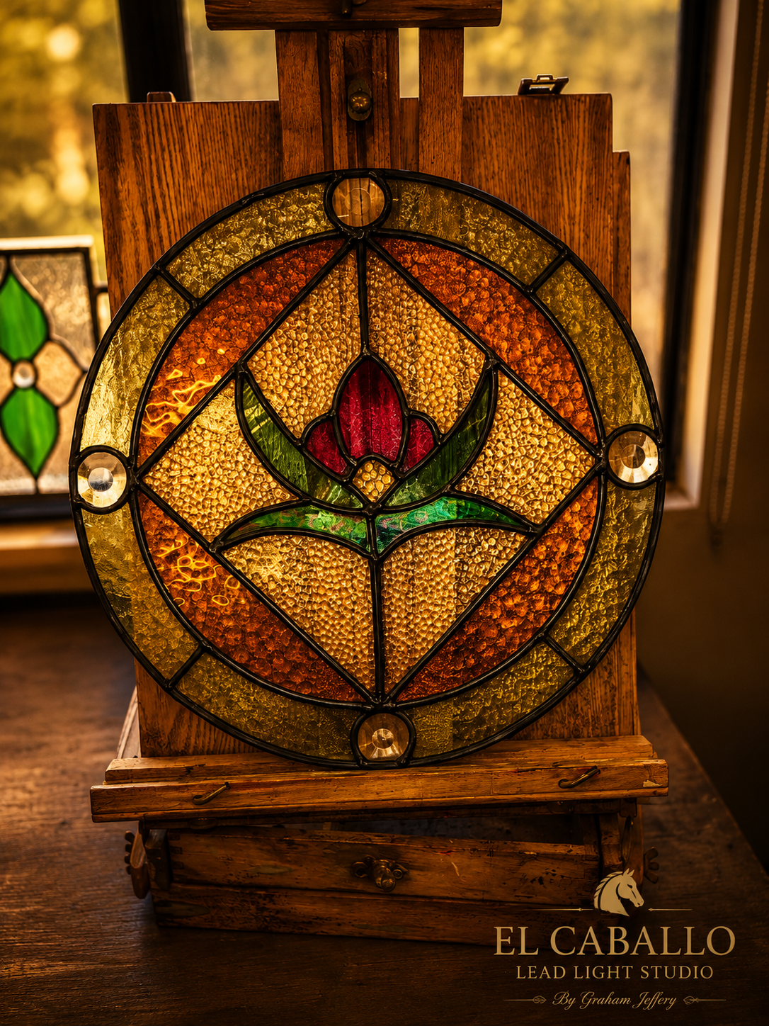 A stained glass panel with a tulip flower design, set on a wooden stand inside a warmly lit room.