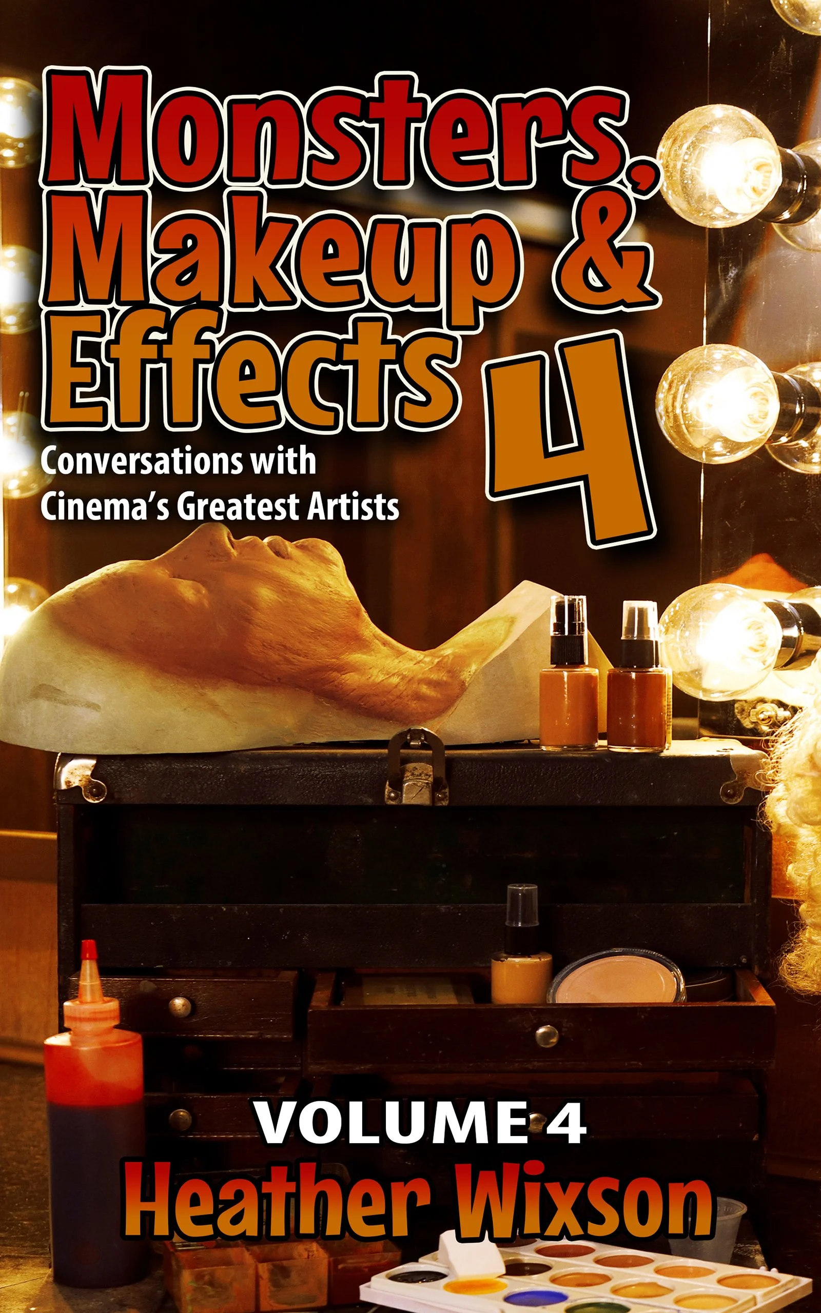 A makeup artist's reflection in a mirror with bright bulbs, showing a makeup workspace with various bottles of makeup products, a large animal skull on the table, and a paint palette with different colors.