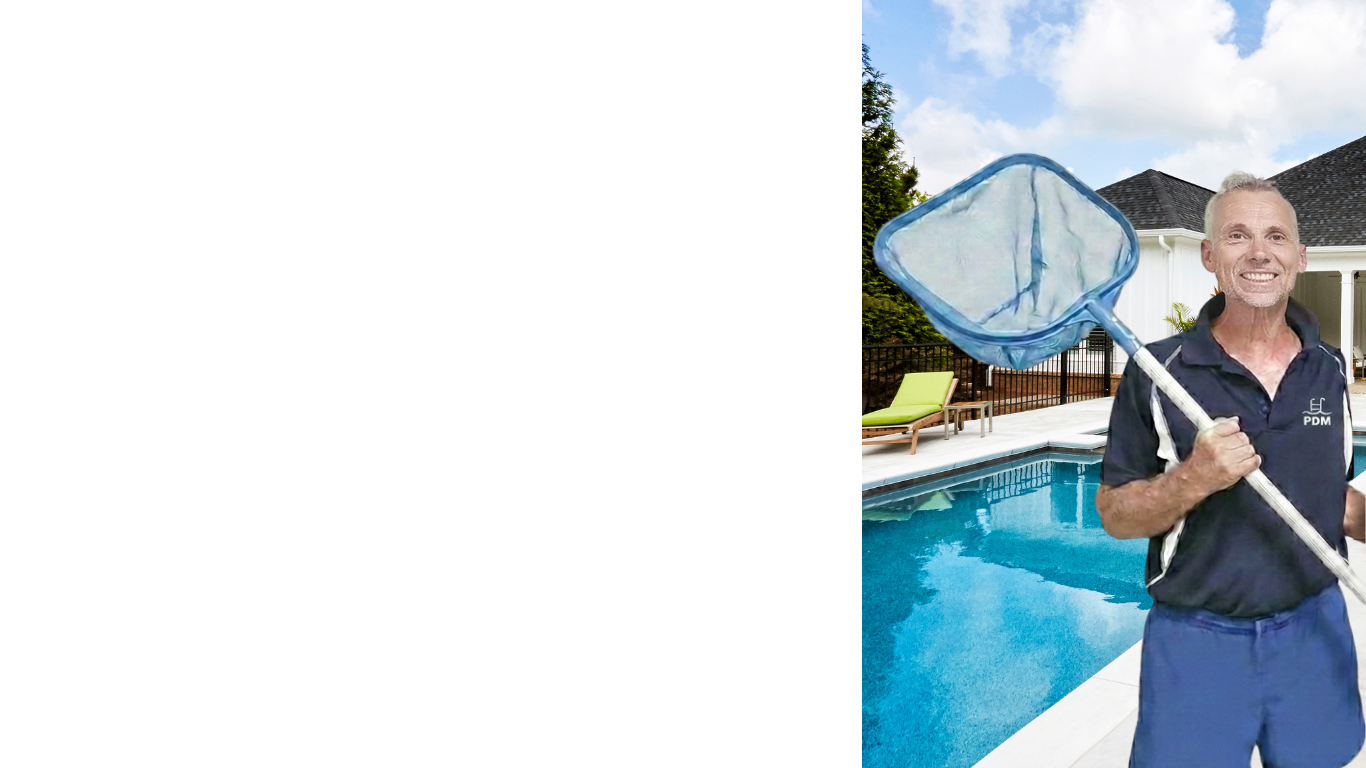 Man smiling and holding a pool skimmer net by a backyard swimming pool with a house and lounge chairs in the background.
