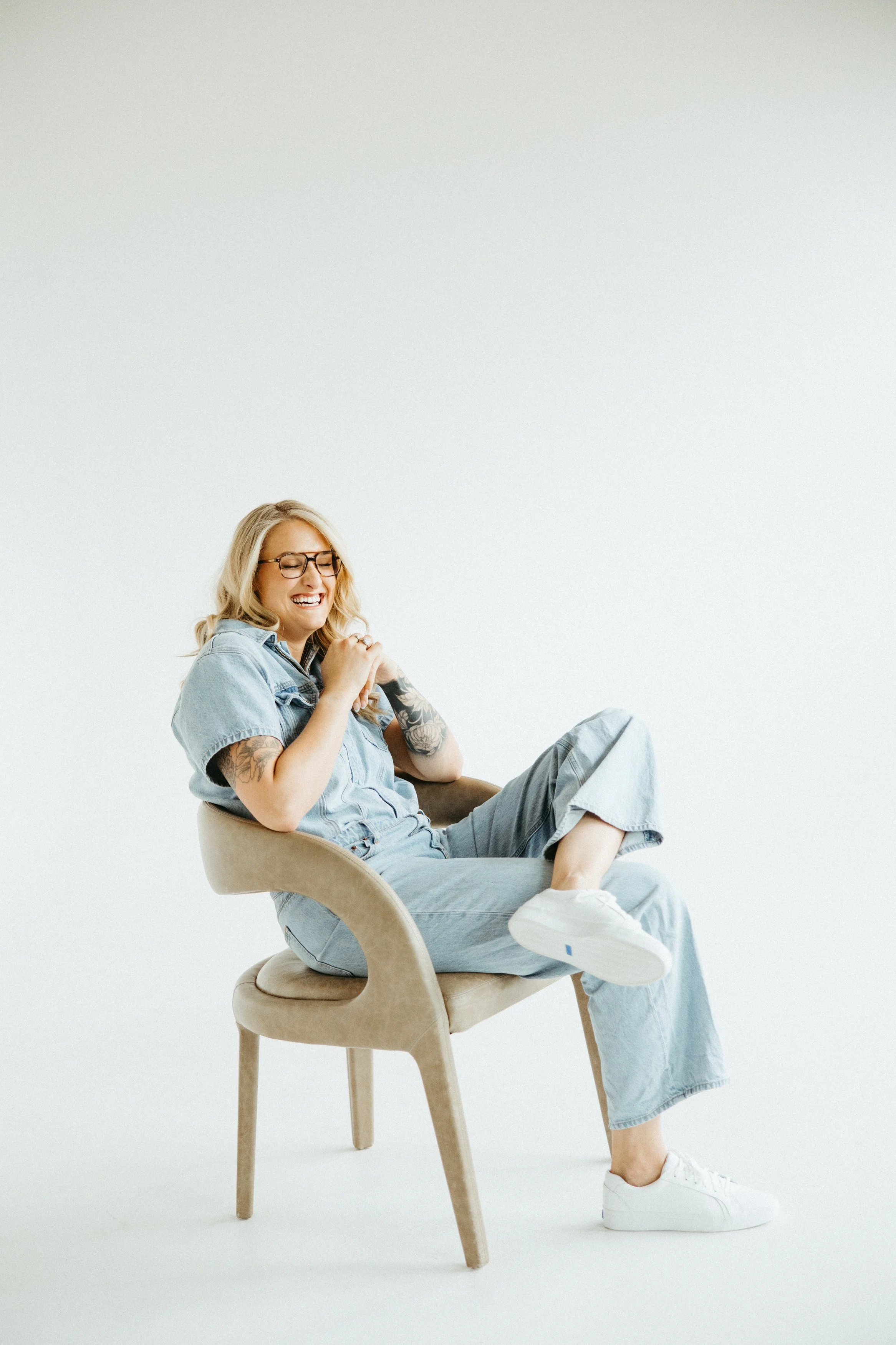 Trauma and PTSD therapist sitting in a chair and smiling in Pennsylvania and Colorado