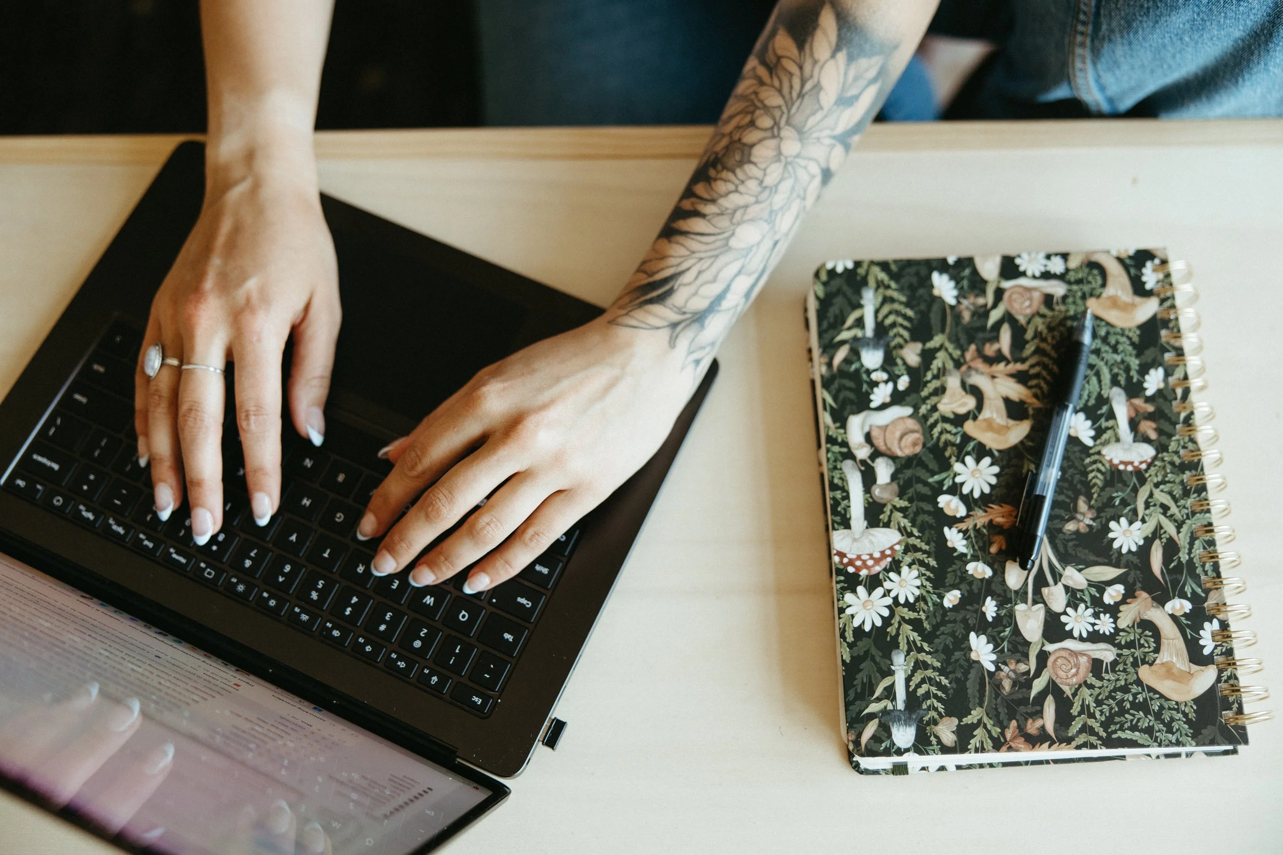 Therapist typing on a laptop while providing online trauma therapy resources for clients seeking EMDR therapy and mental health support in Philadelphia, PA and Denver, CO.