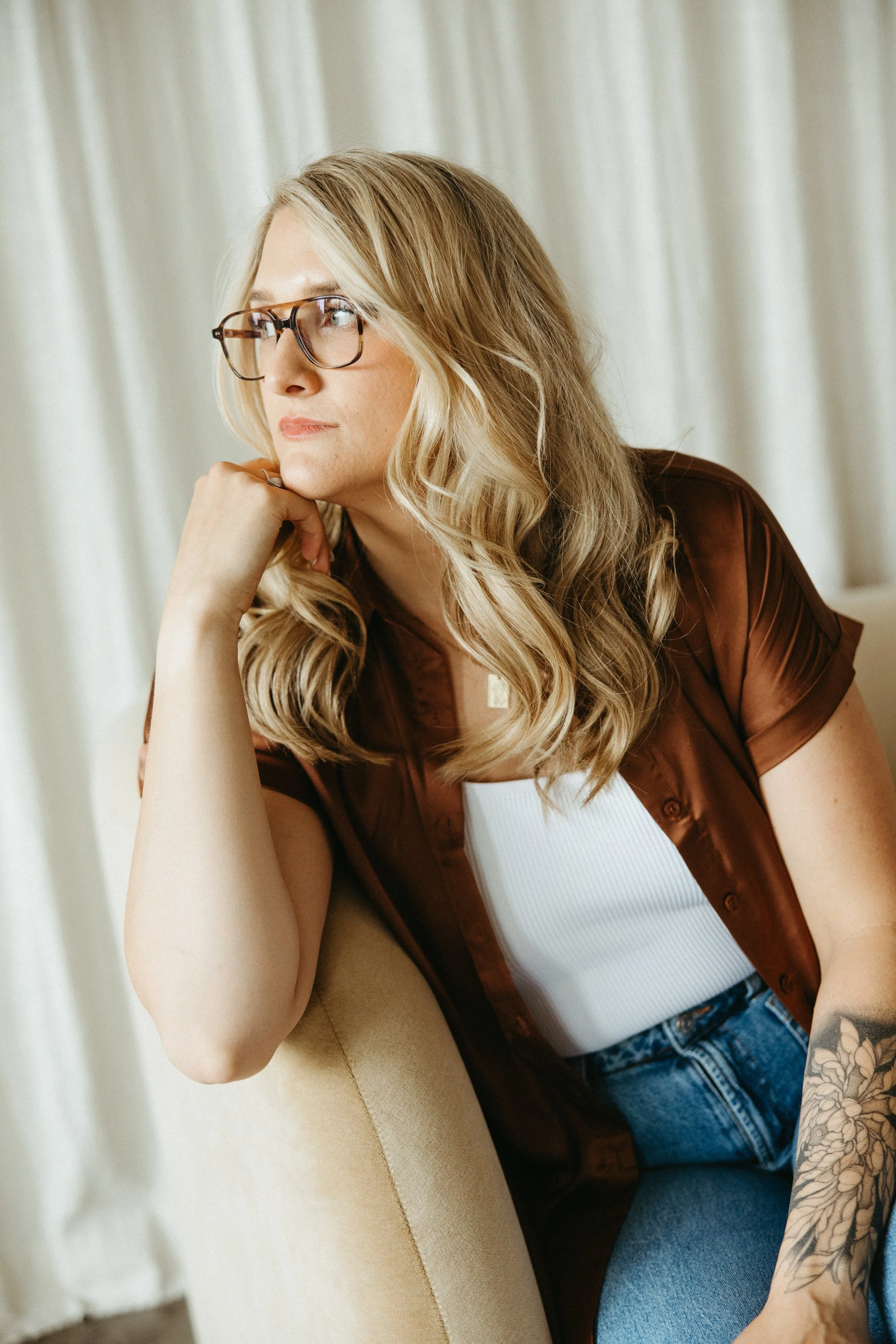 Trauma and PTSD therapist looking thoughtfully to the side