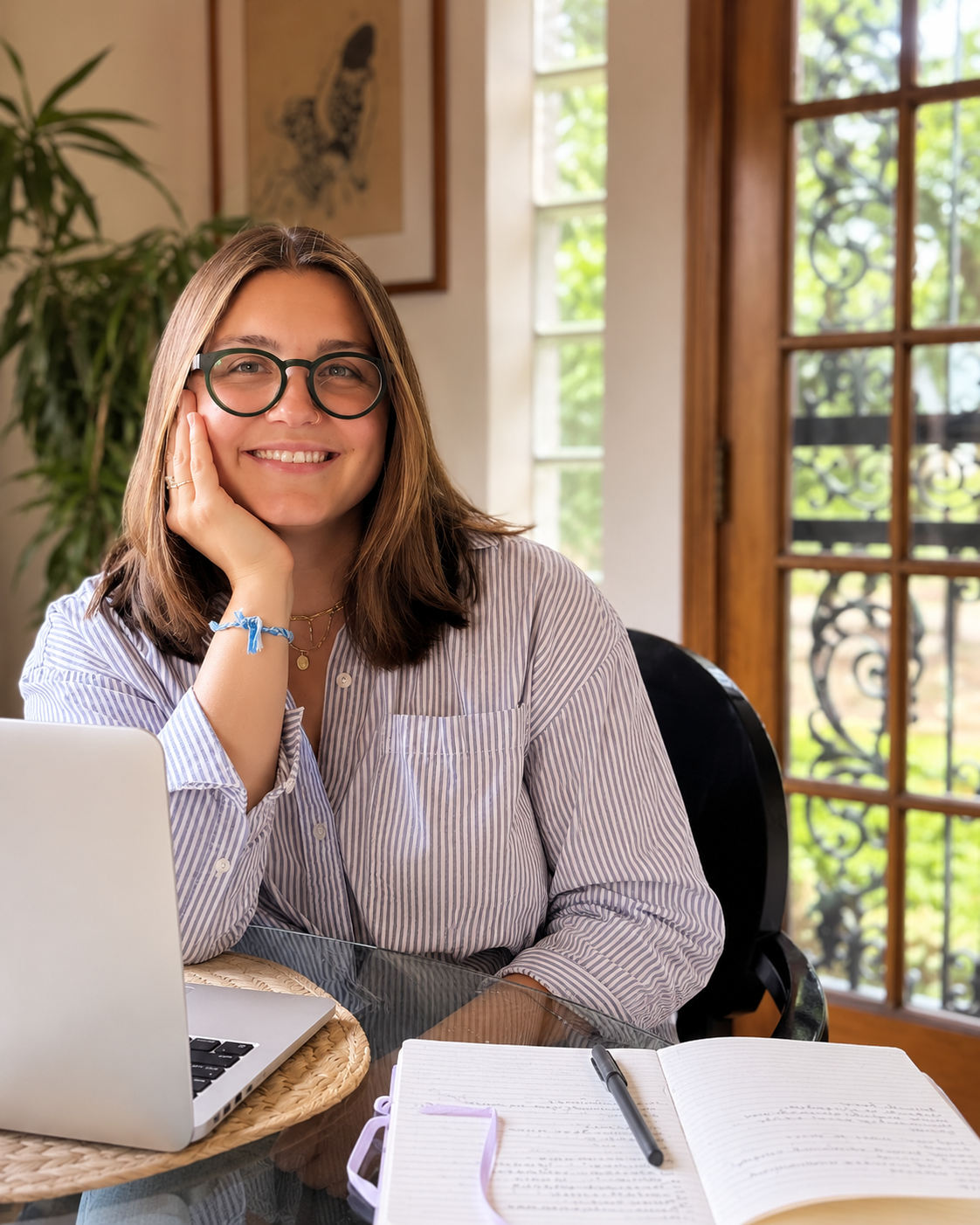 Rosa Vitti, LSW, trauma therapist in Philadelphia, Pennsylvania, smiling while sitting at a desk.