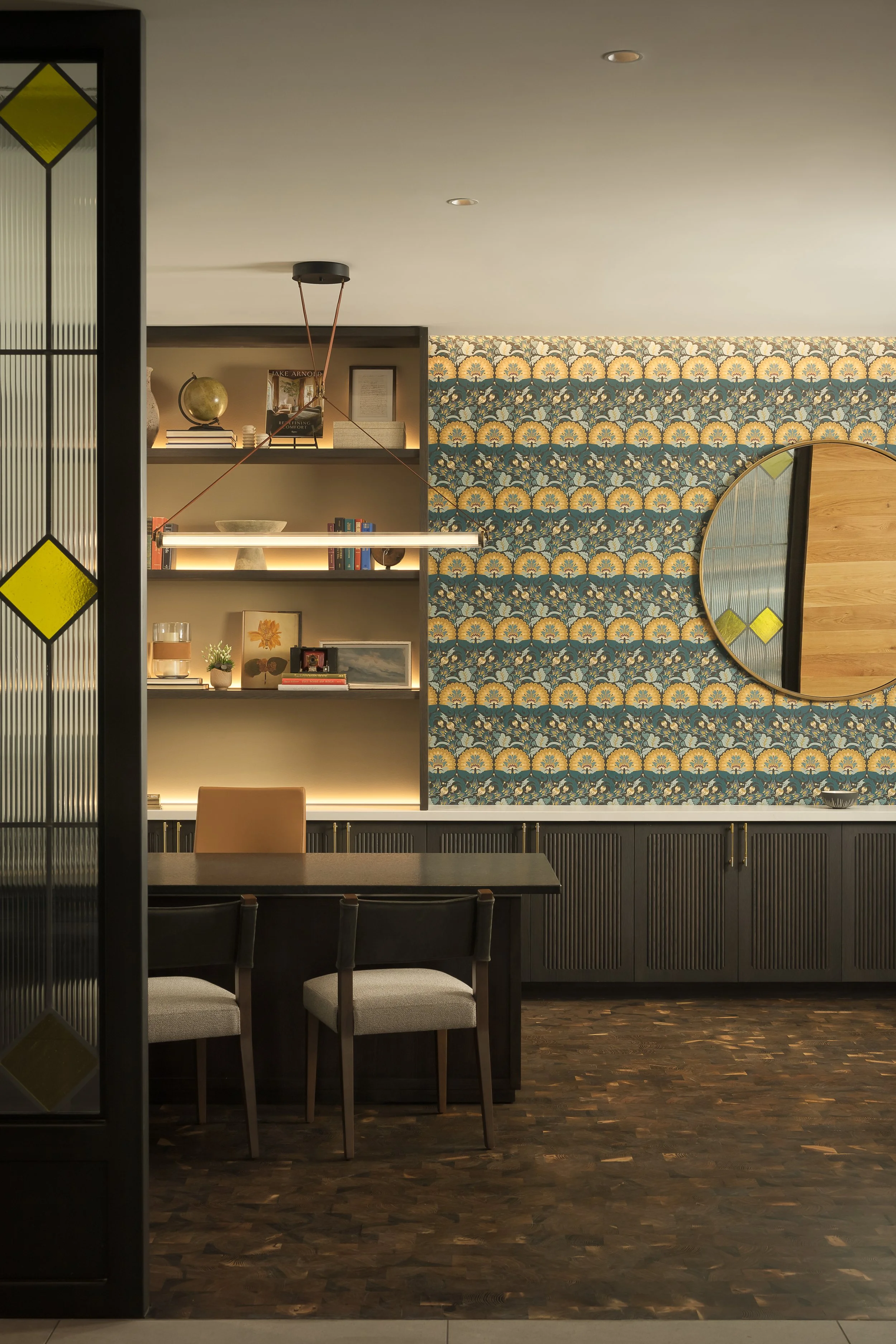 On-site convenience retail with patterned tile feature wall and curated open shelving — residential amenity interior design, 333 Water Milwaukee WI