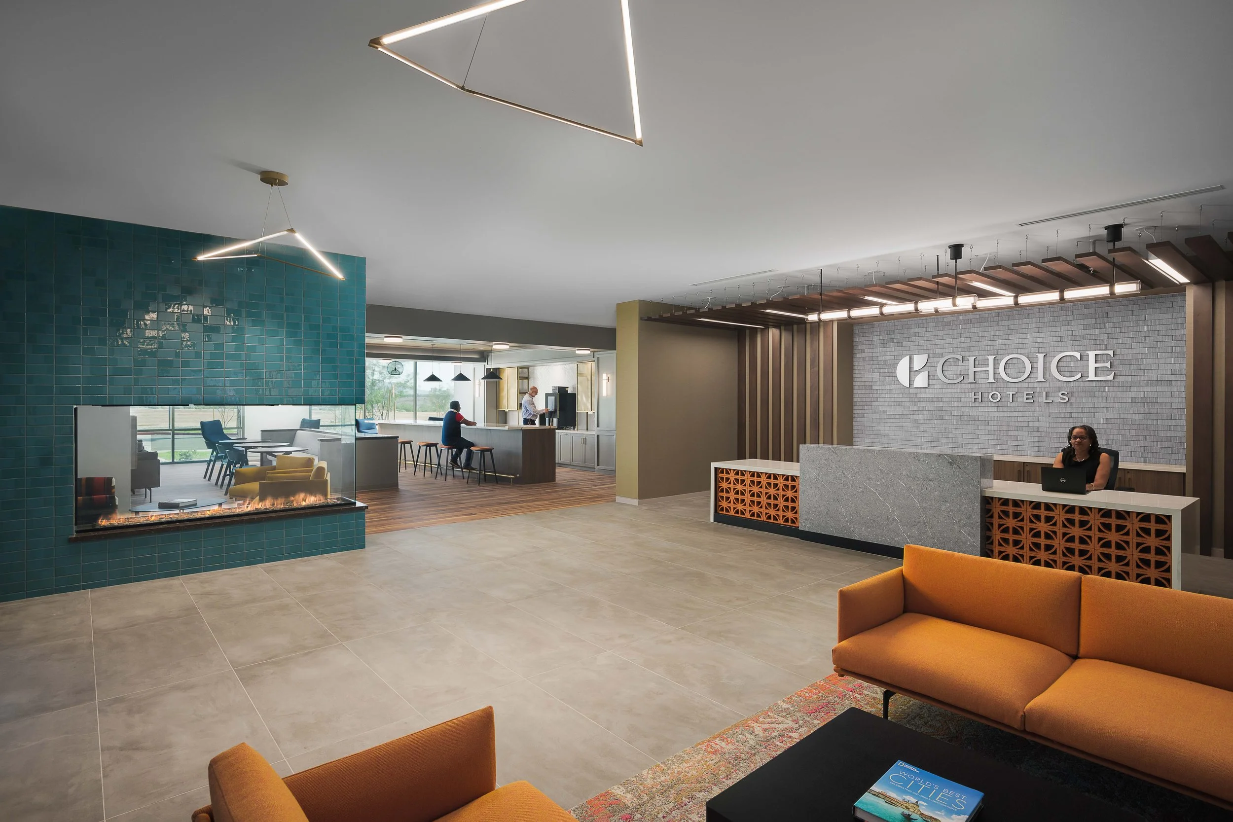 Choice Hotels branded lobby reception with orange lounge seating and backlit corporate logo wall — commercial interior photography, Scottsdale AZ