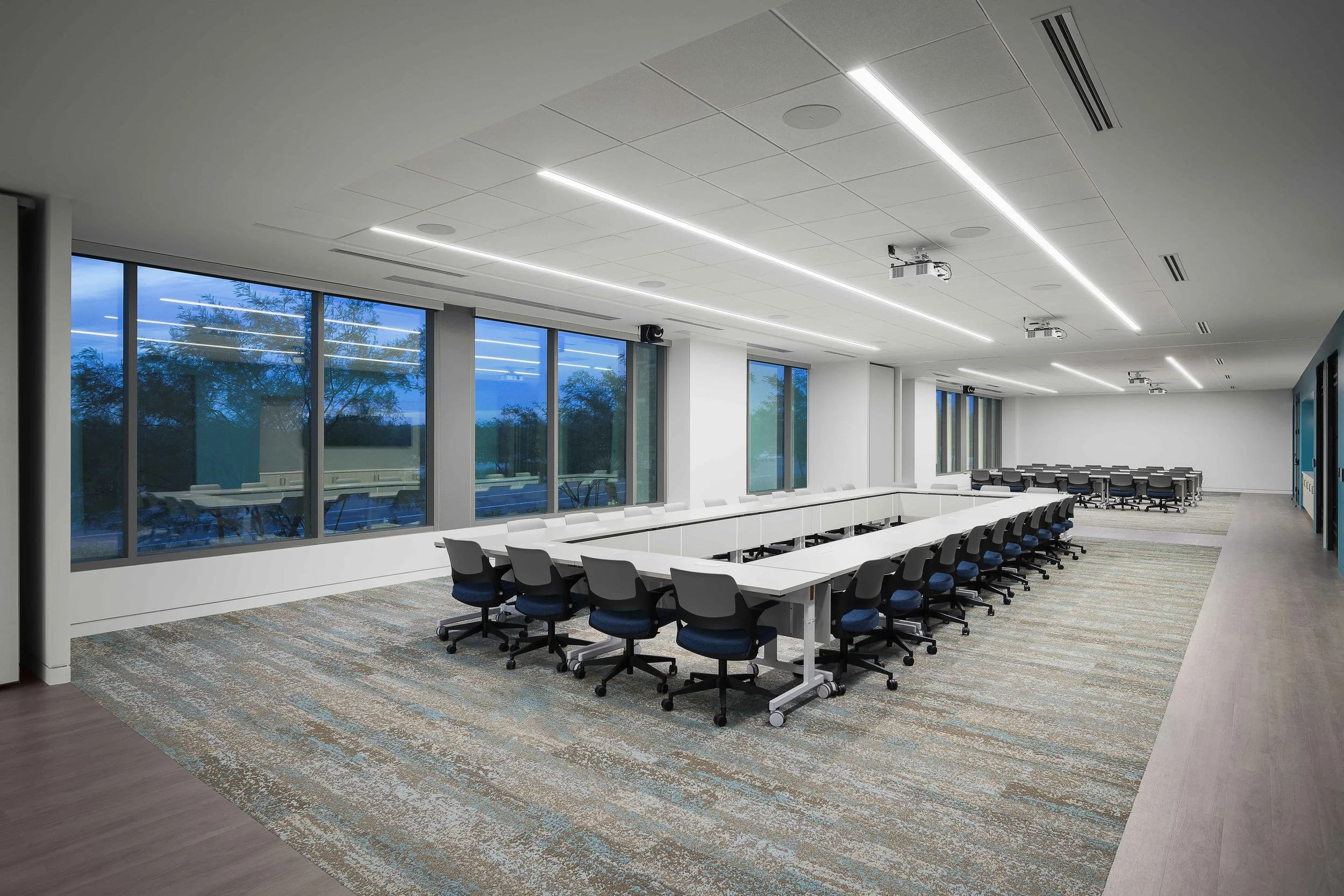 Bright daylit office floor with workstations, linear LED ceiling, and panoramic Scottsdale views — commercial architecture photography, Choice Hotels Technology HQ