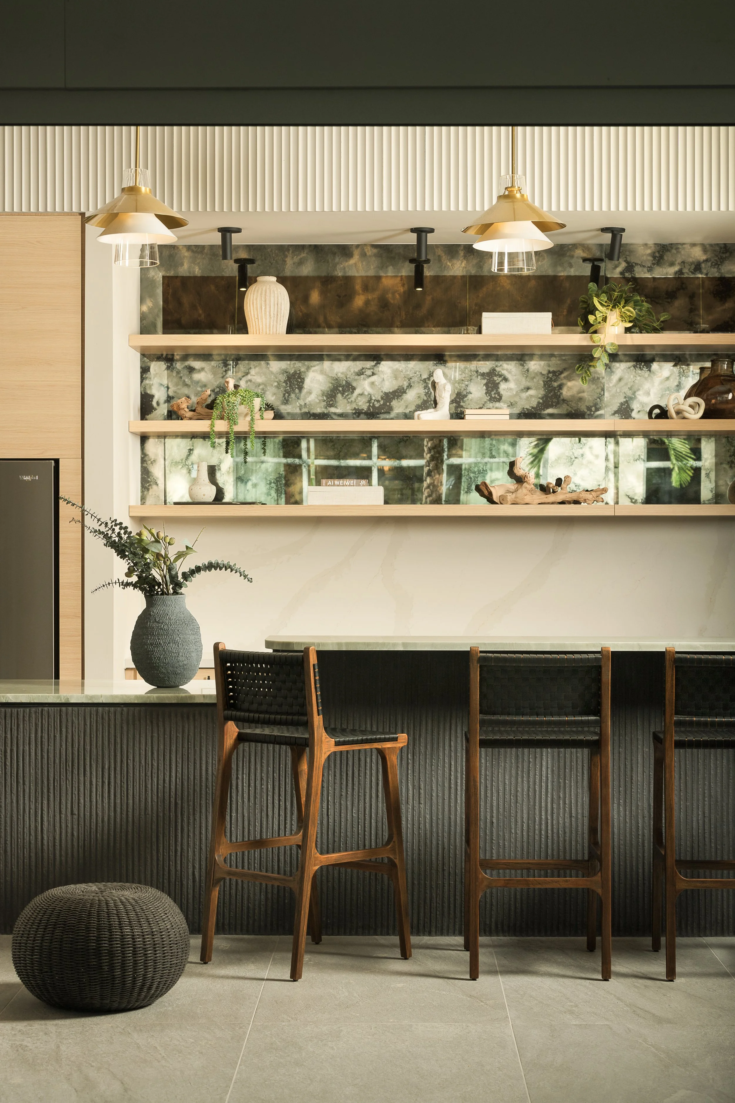 Upscale hotel bar and lounge with warm lighting and textured wall panels — hospitality interior photography