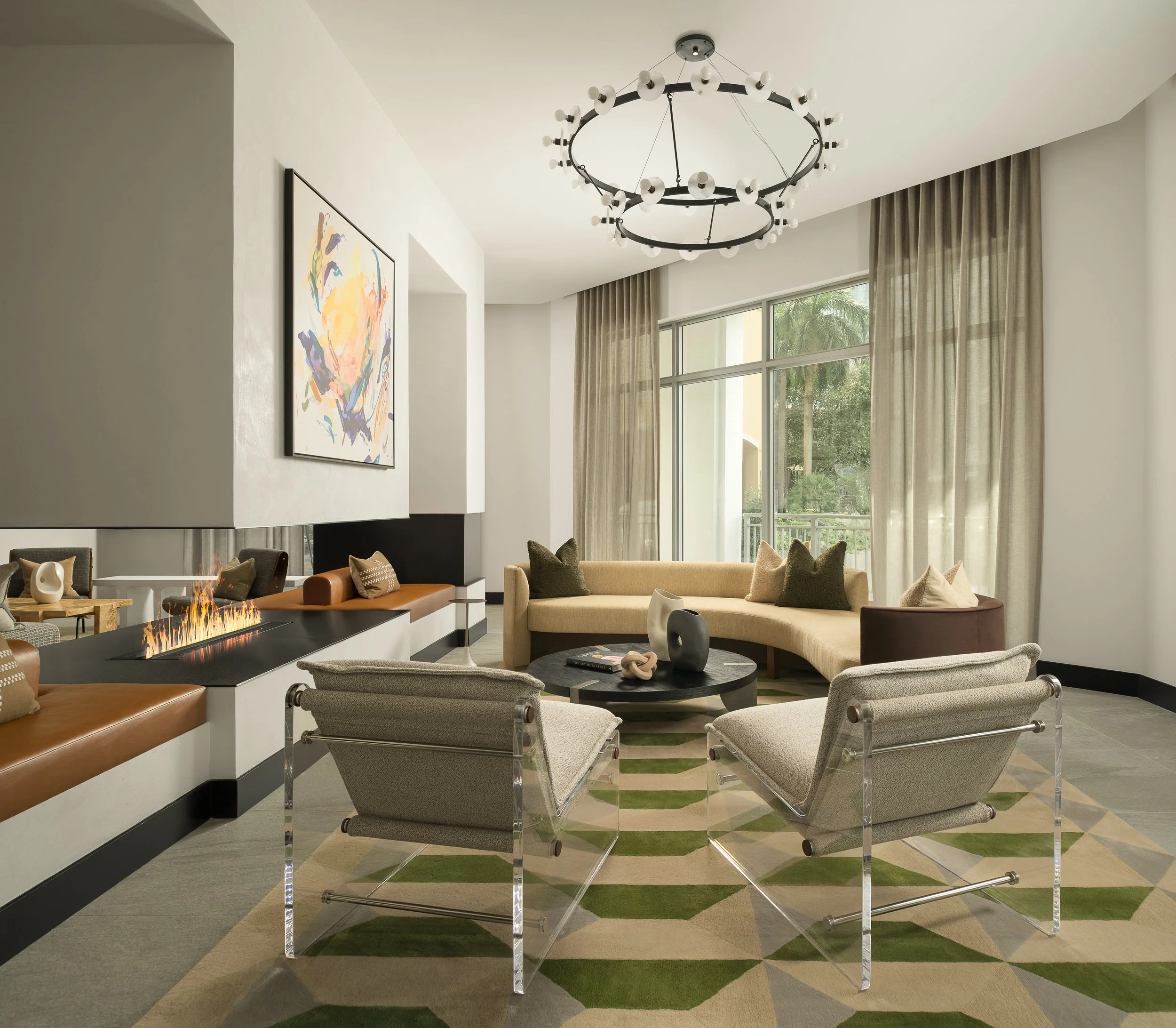 Chic apartment sitting room with graphic geometric rug, modern seating, and statement chandelier — interior design photography, Coasterra Fort Lauderdale FL