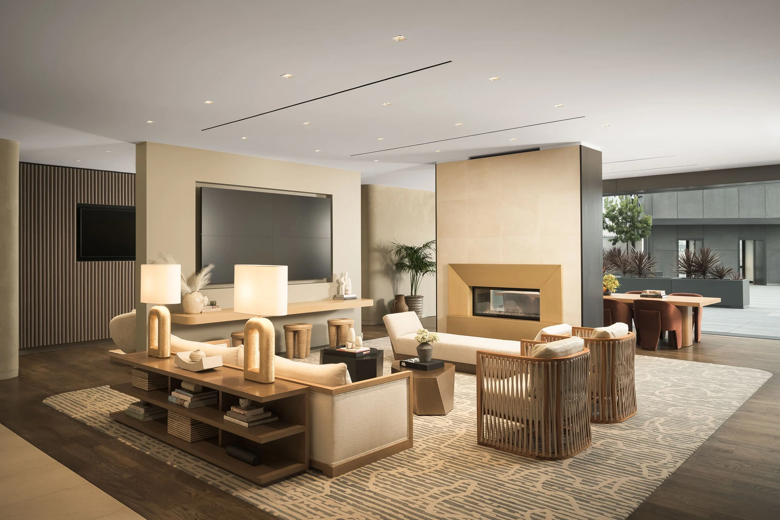 Resident lounge with linear fireplace, flat screen TV, and contemporary upholstered seating — luxury commercial interior photography, Entrada LA
