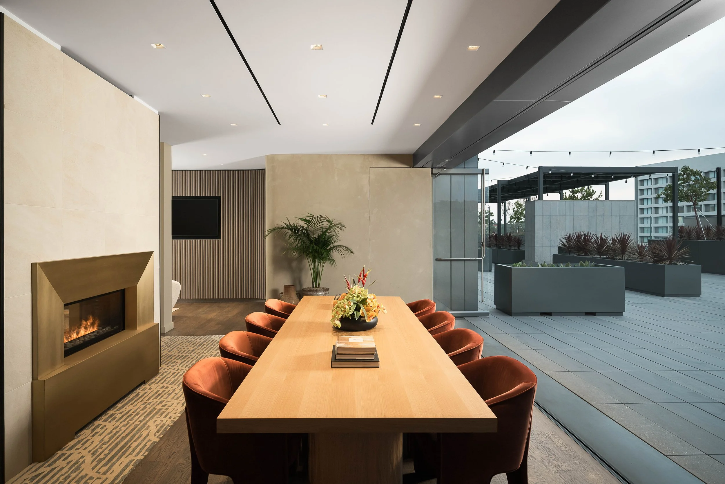 Private conference room with long wood table, leather chairs, and floor-to-ceiling outdoor view — commercial interior design photography, Entrada Los Angeles CA