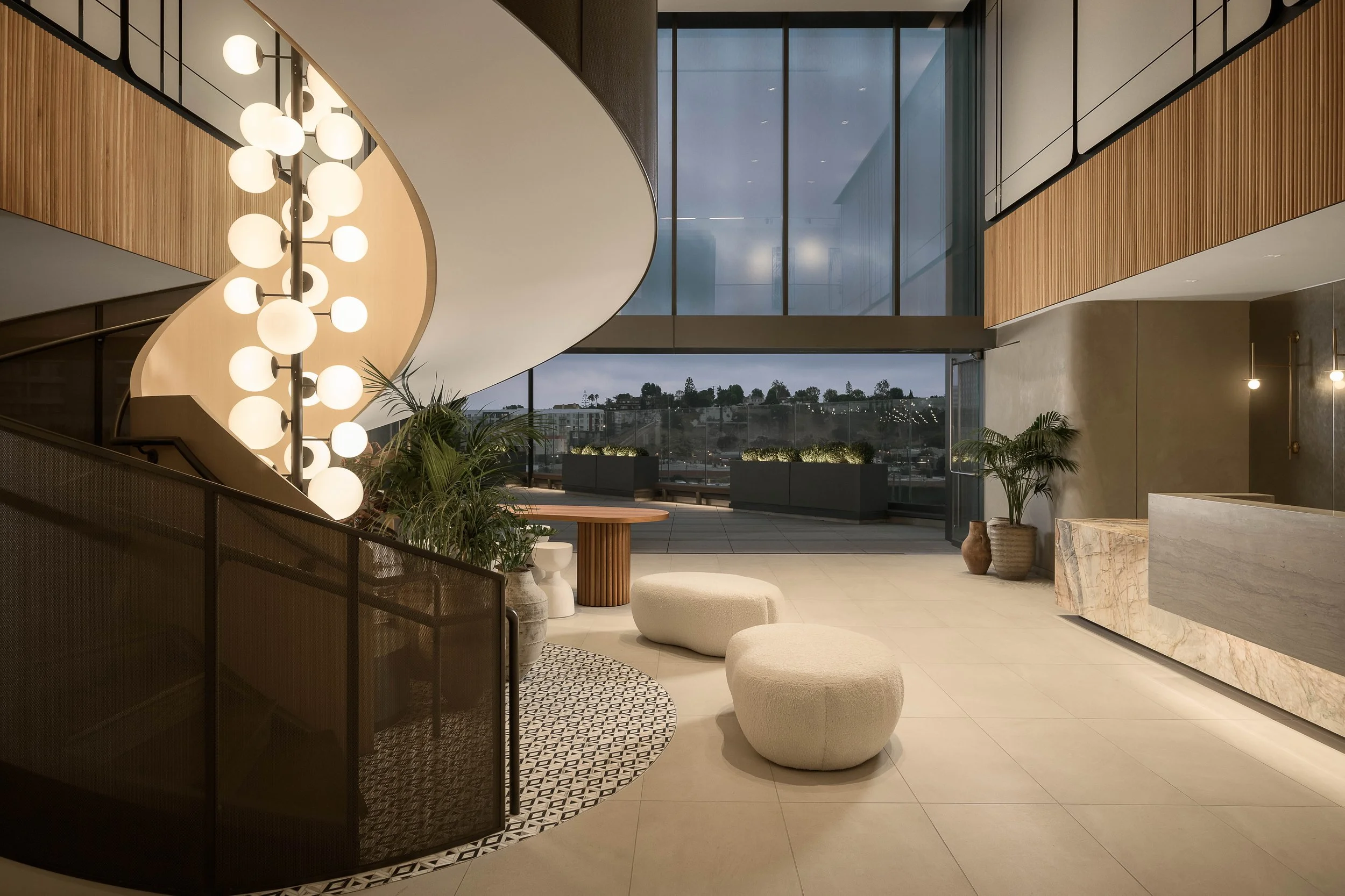 Modern curved interior with neutral palette and architectural ceiling detail — luxury residential photography