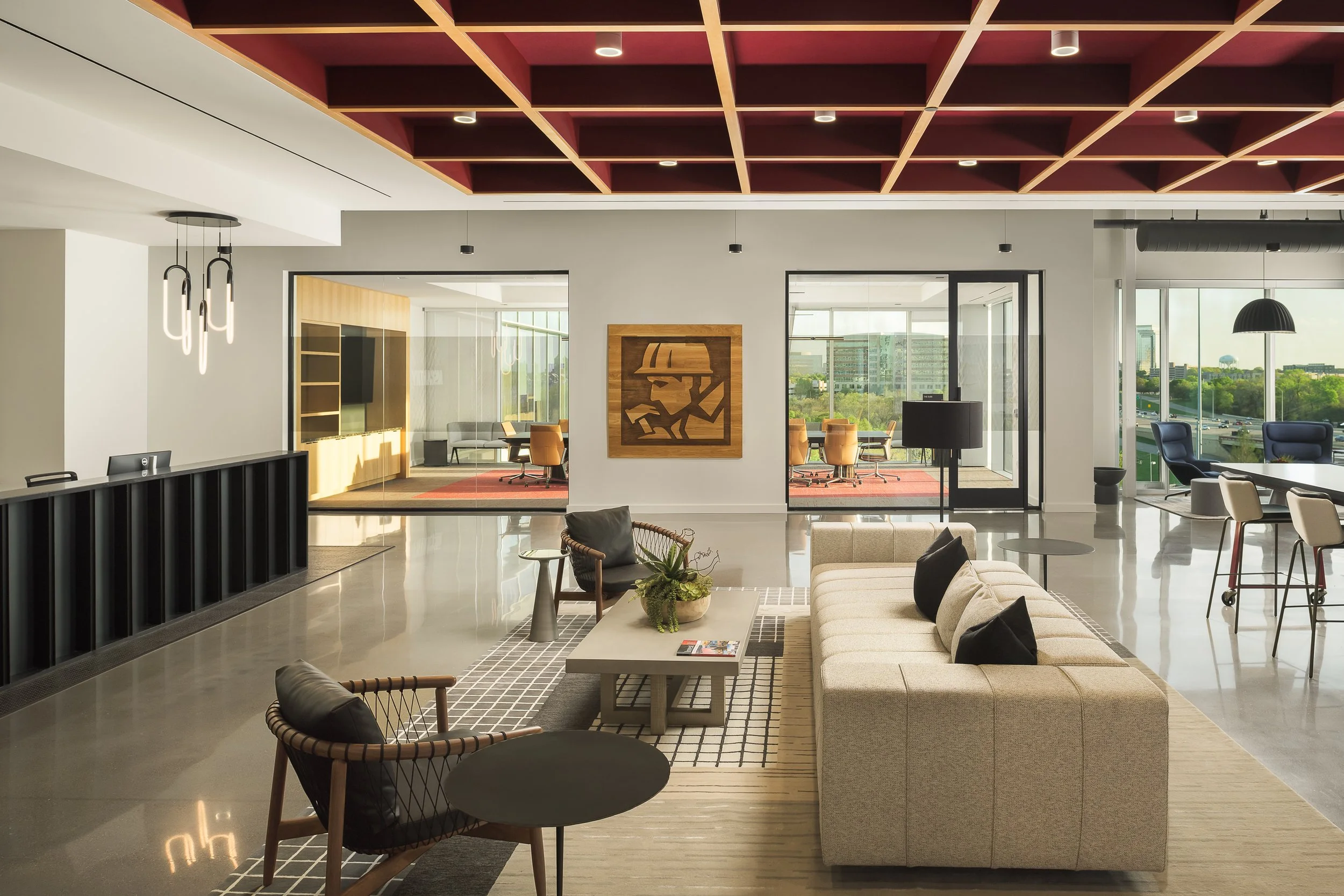 Corporate commons lounge with dark red coffered ceiling, casual seating, and open plan layout — commercial office interior photography, McCarthy Richardson TX