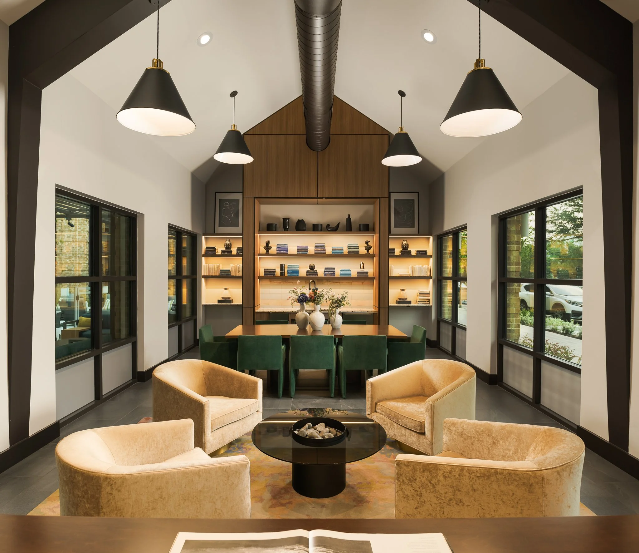 Luxury hotel corridor with dramatic chandelier and arched doorways — hospitality interior photography