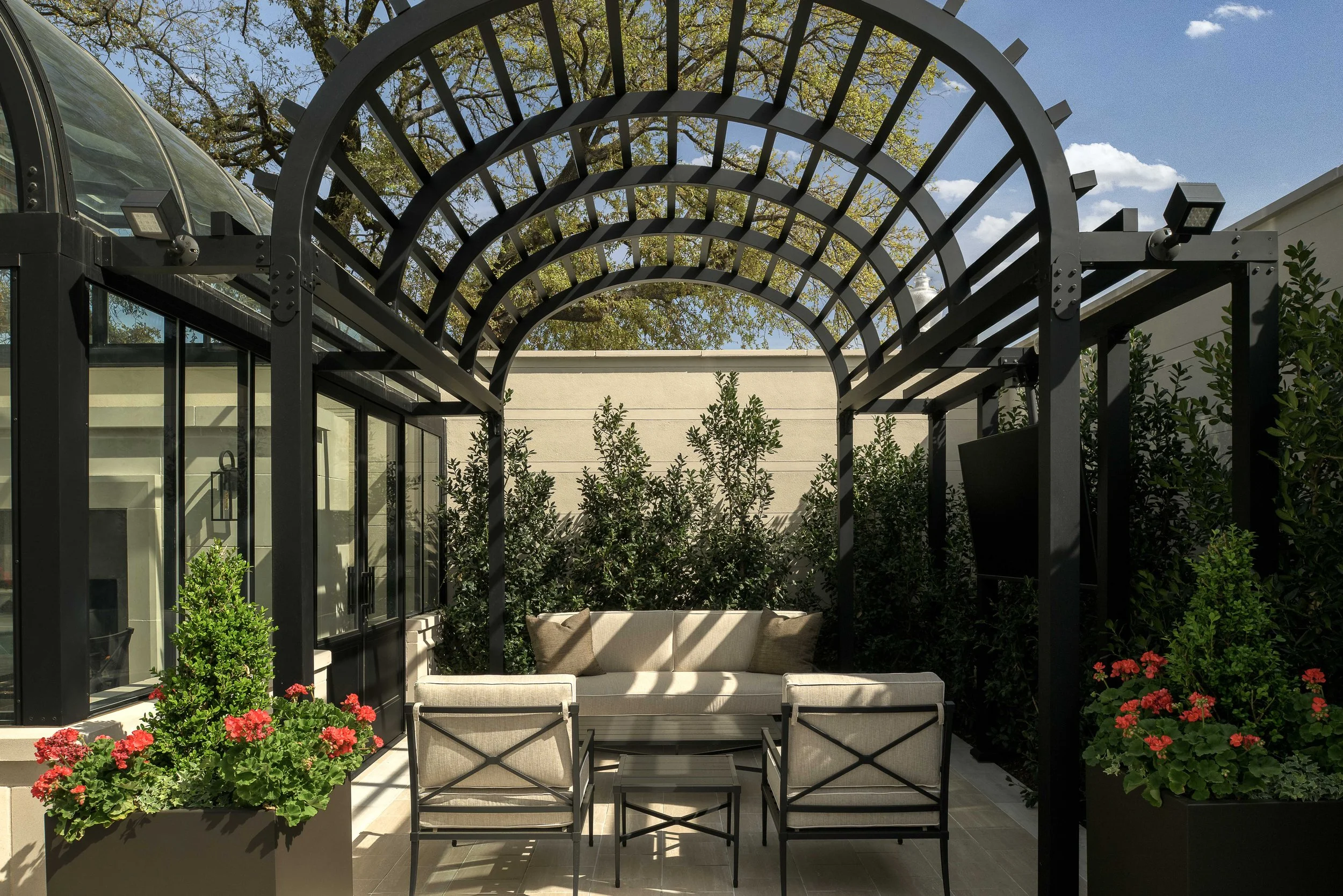 Outdoor garden terrace with iron pergola structure and lush landscaping — luxury residential architecture, The Galatyn Dallas TX