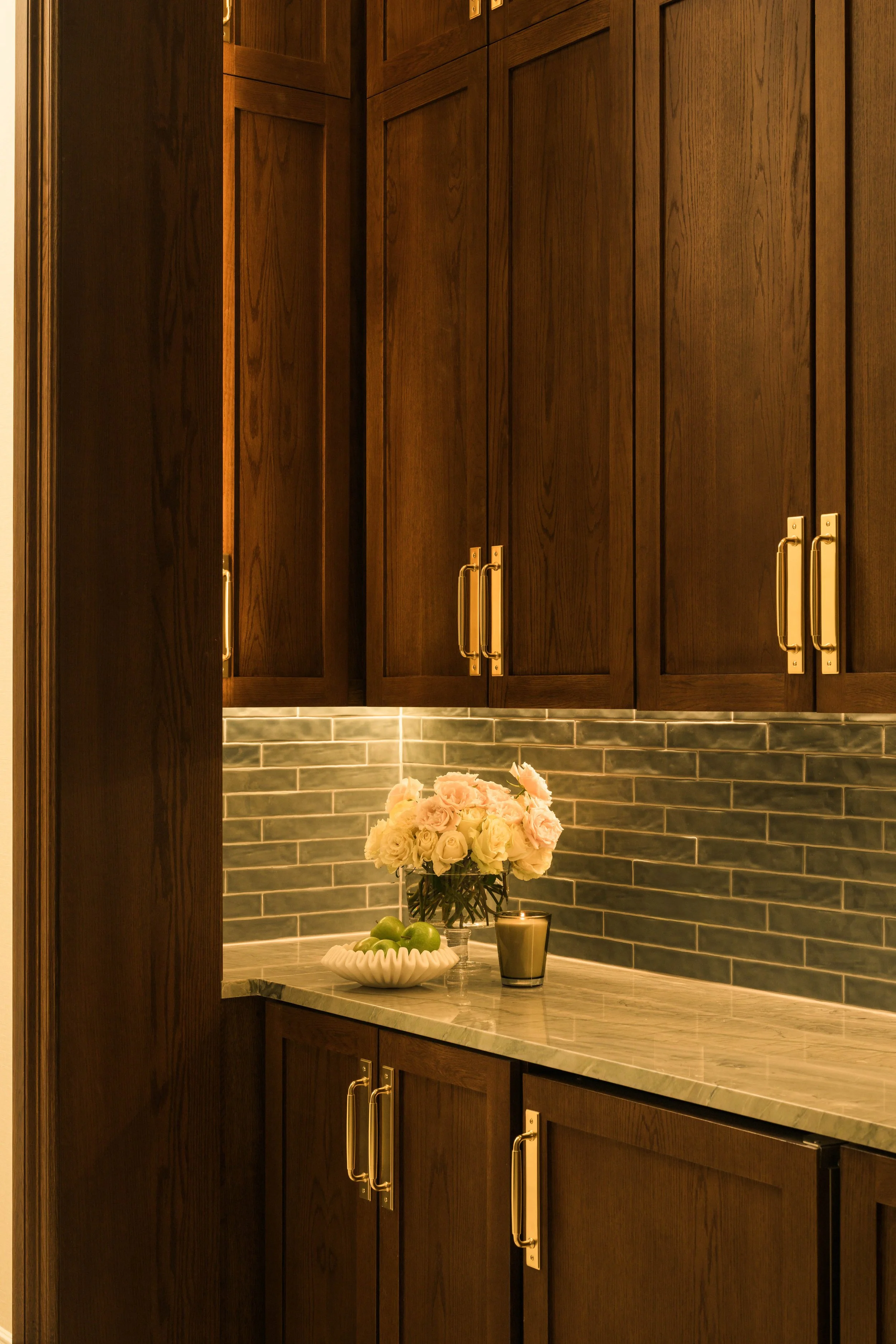 Warm marble countertop with decorative vase and floral detail — luxury residential interior design photography, Dallas TX