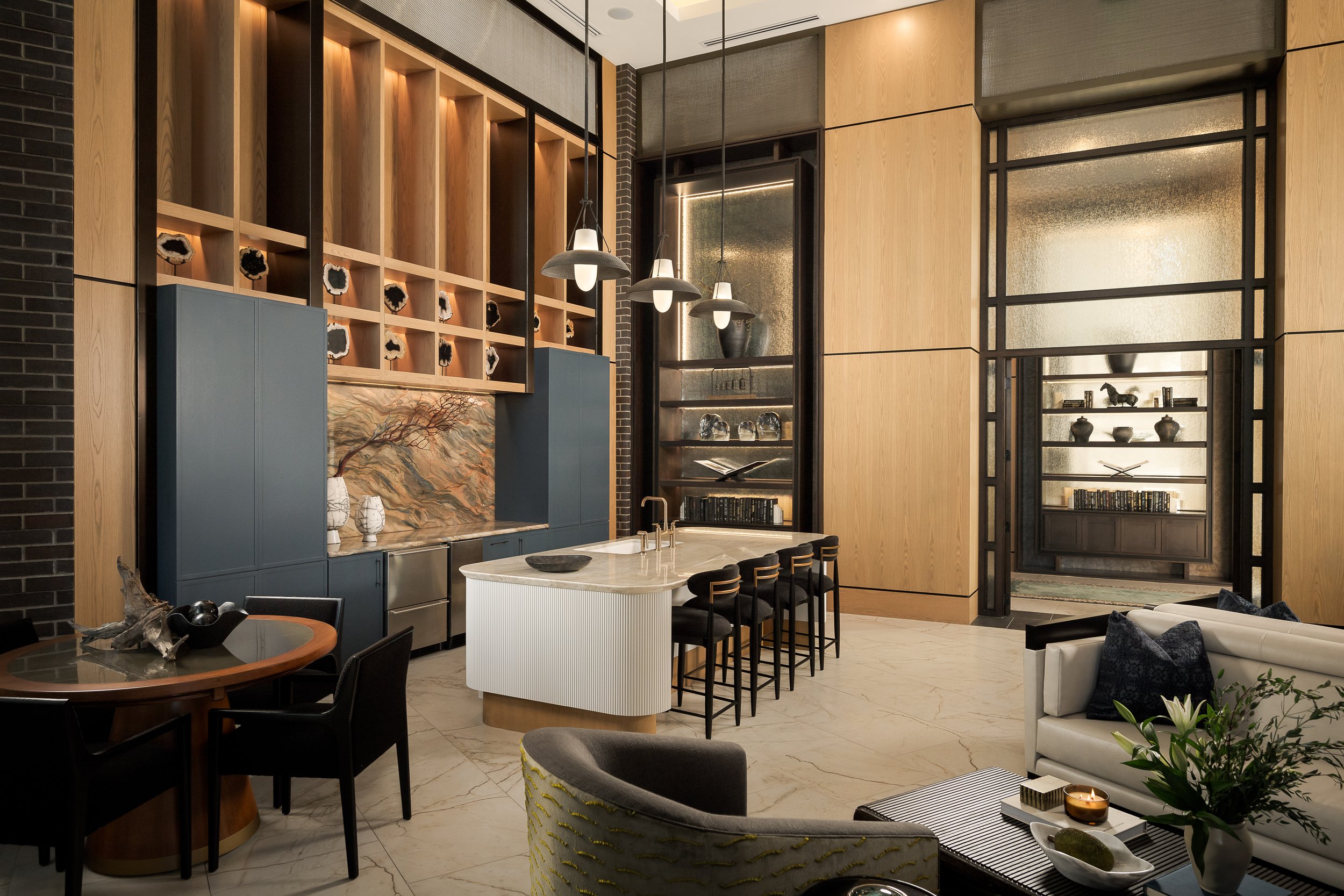 Private dining space with curved white bar counter and contemporary pendant lighting — residential amenity interior design, The Oliver Dallas TX