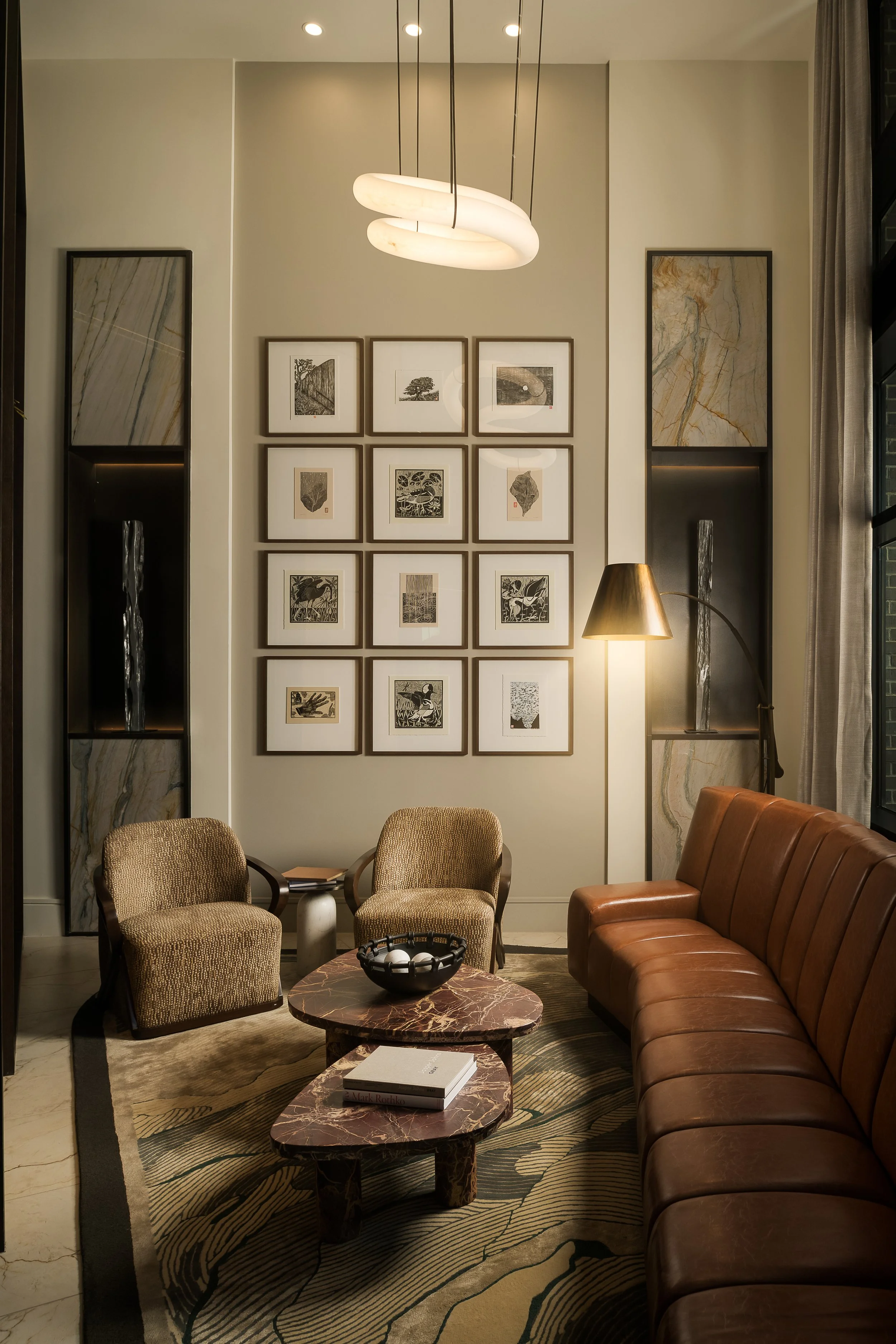 Curated gallery wall with framed art, leather banquette, and warm ambient lighting — residential interior design photography, Dallas TX