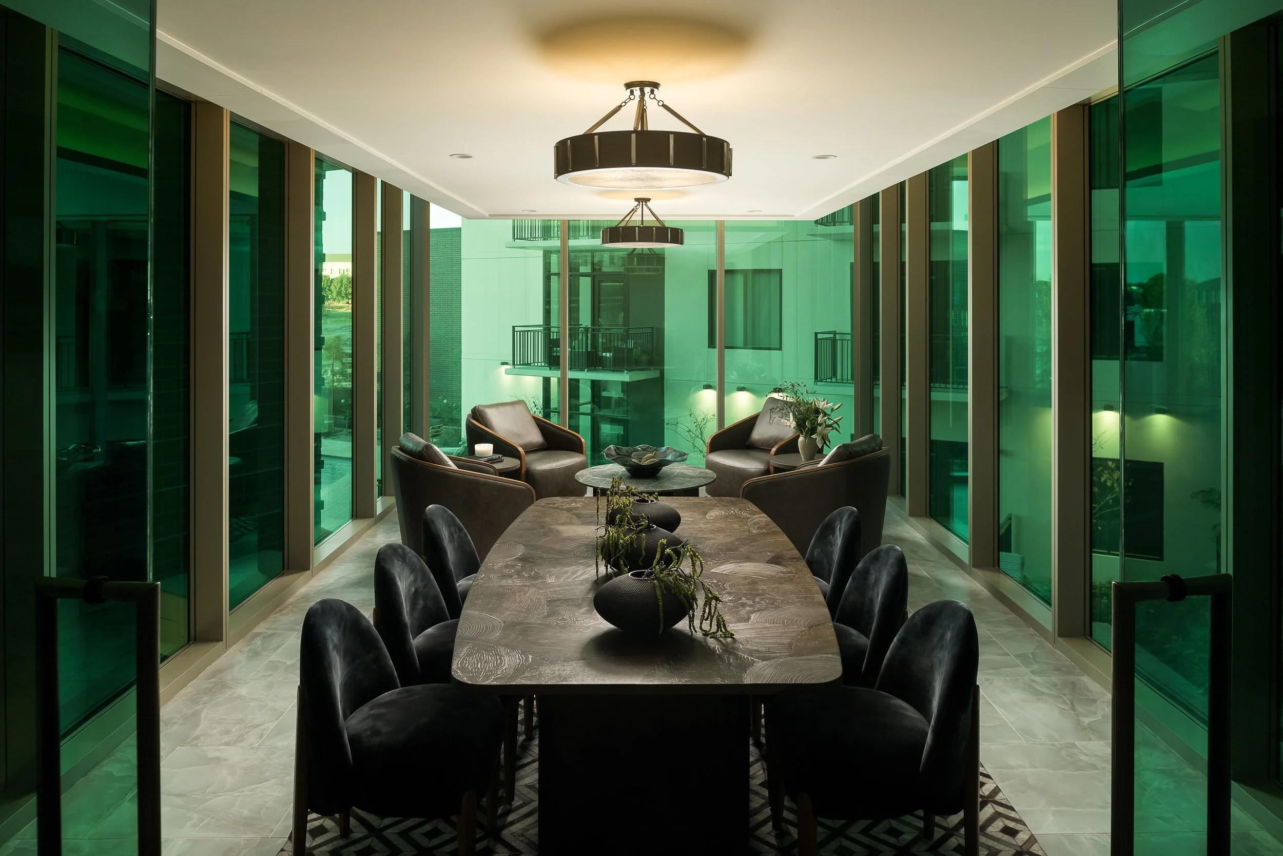 Emerald-toned private dining room with statement chandelier and dark furnishings — luxury apartment interior design, The Oliver Dallas TX